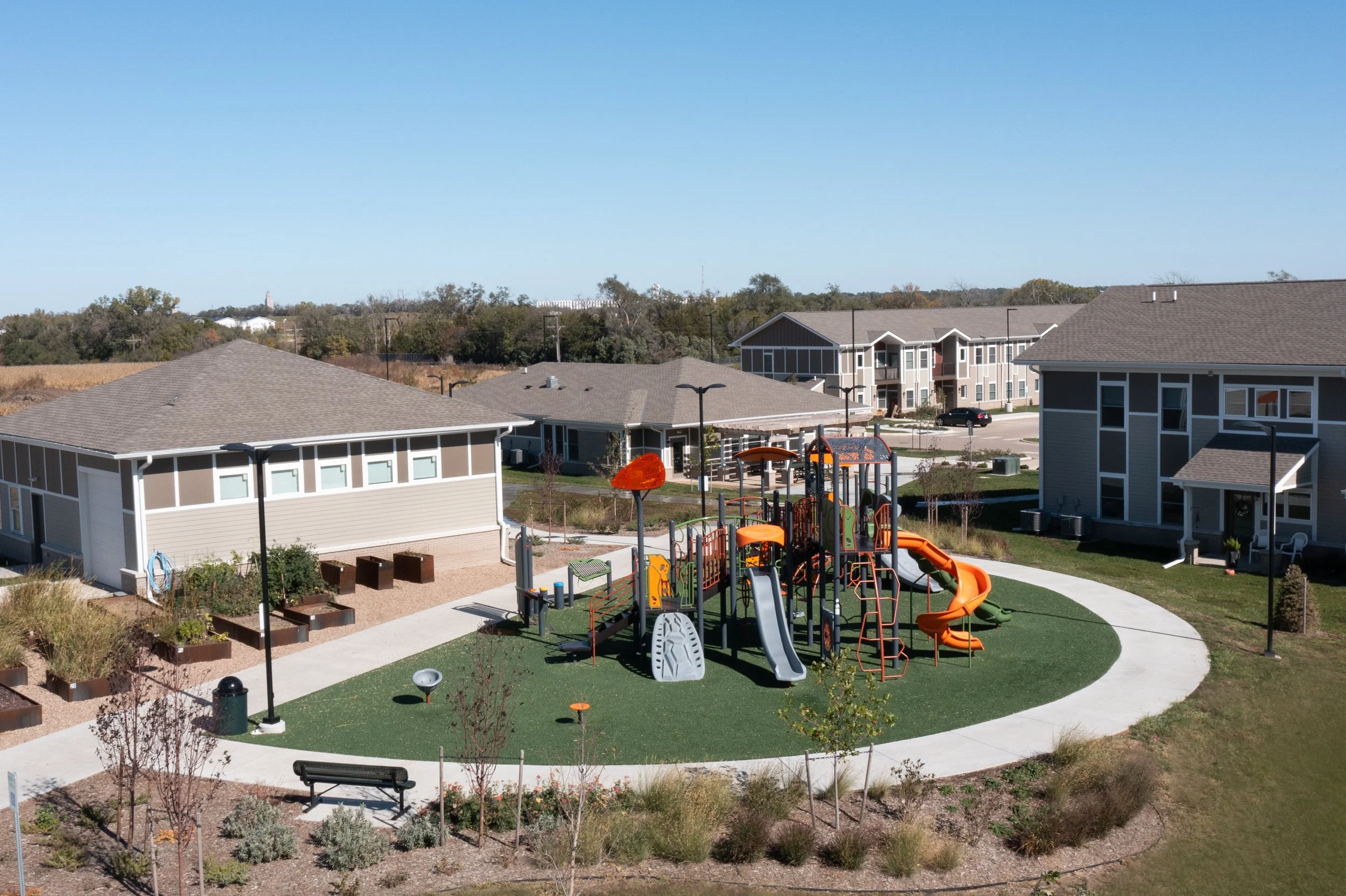 Aerial image of multi family living.  playground and courtyard