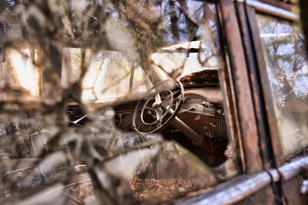 image of broken car windows looking at the steering wheel

