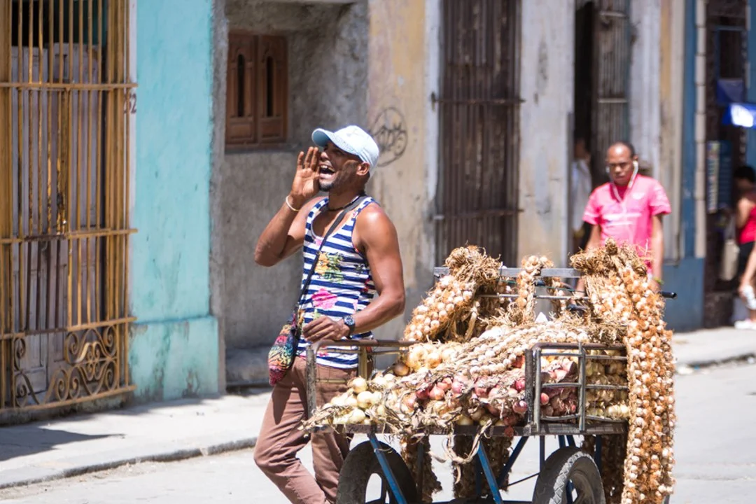 garlic and onion produce vendor yelling in the streets of Havana Cuba
