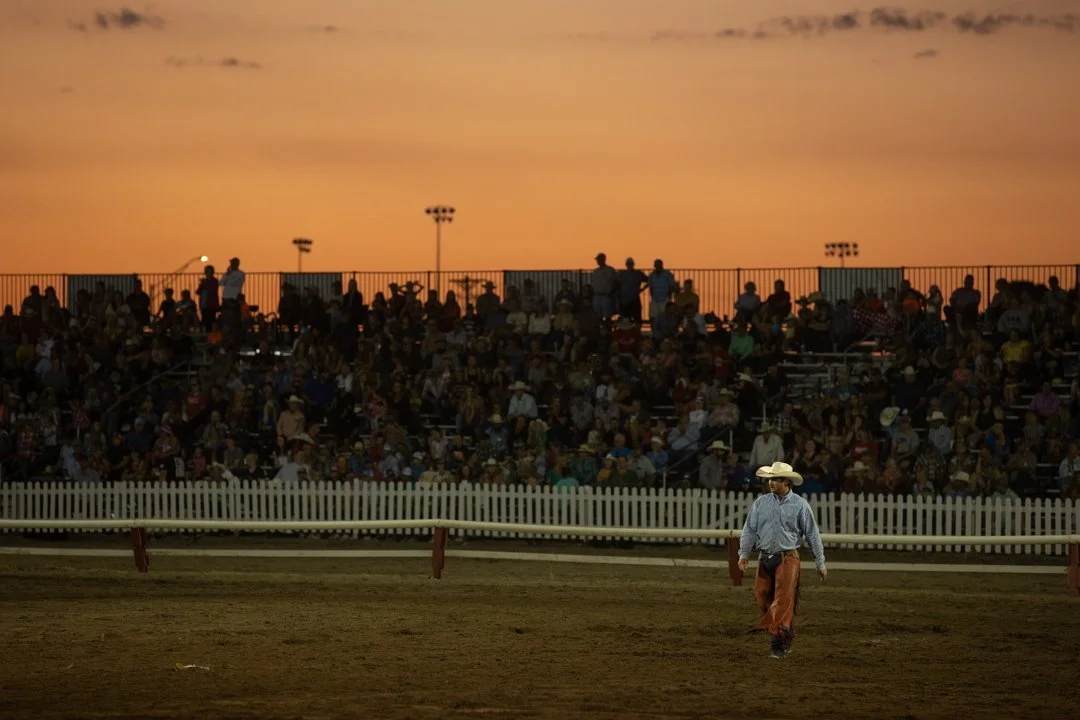 landscape image of cowboy walking in the rodeo arena, shot by commercial photographer Corey Rourke

