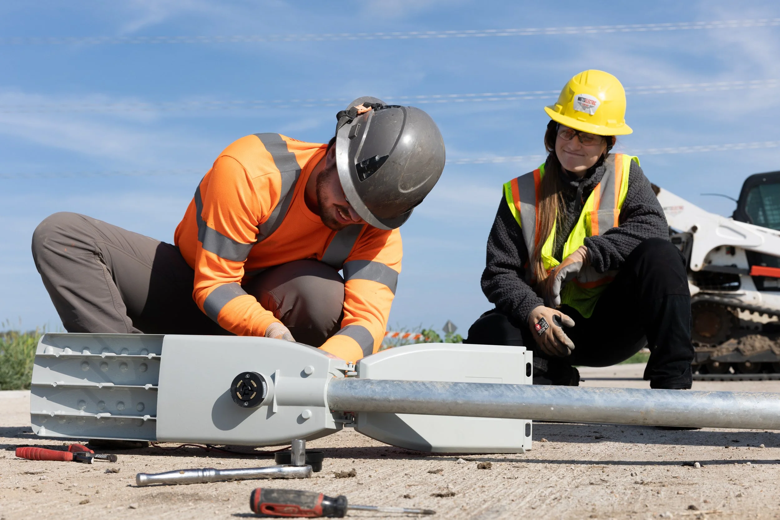 Construction workers installing a lamp on light poles, shot by commercial photographer Corey Rourke