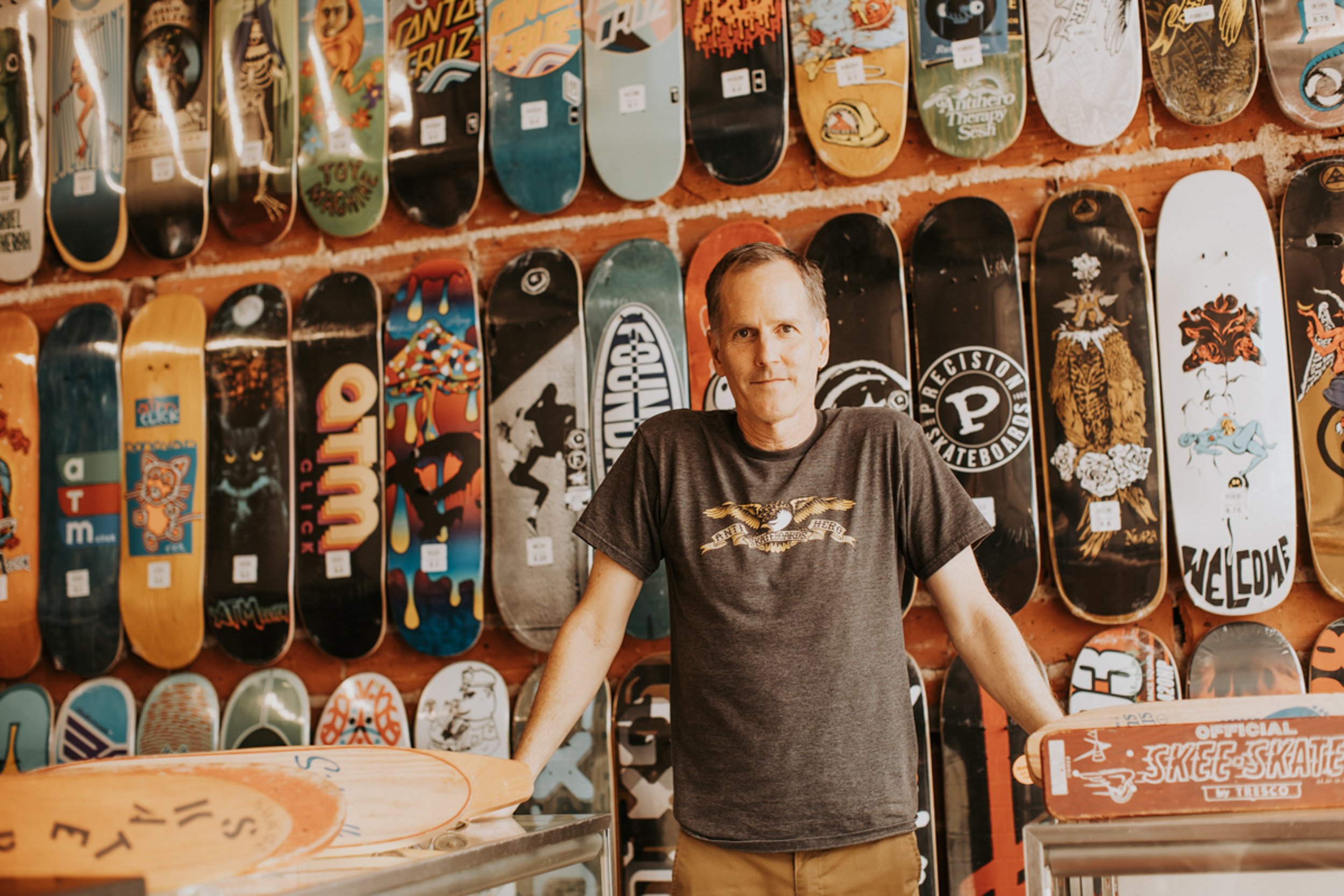 male standing in front of a wall of skateboards, shot by commercial photographer Corey Rourke
