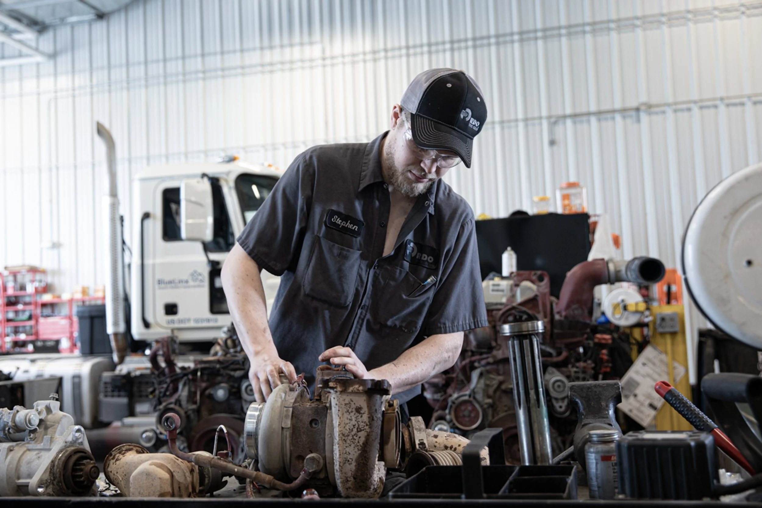 mechanic workin on parts in a shop, shot by commercial photographer Corey Rourke
