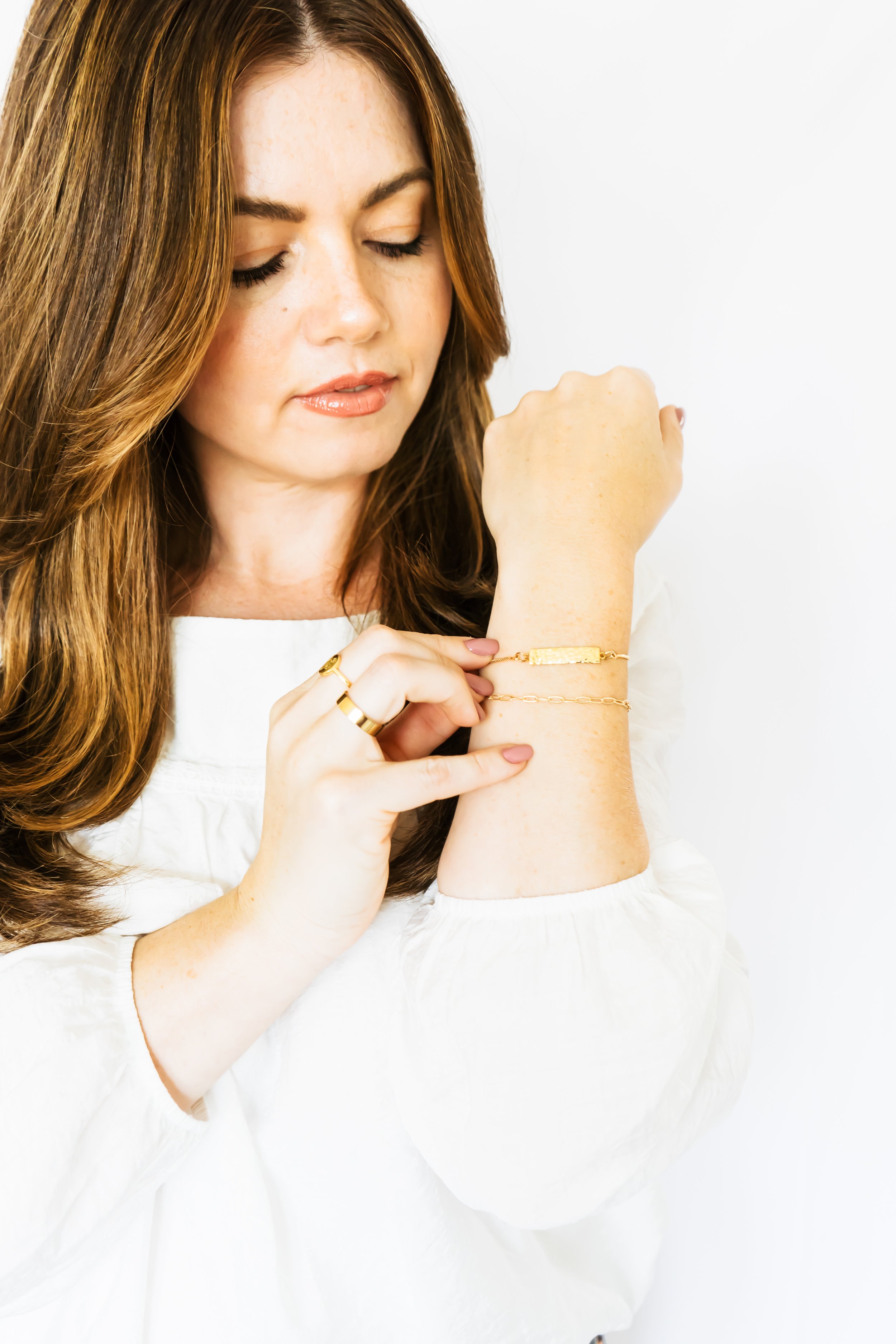 A jewelry designer from Cambridge Ontario Canada admiring her bracelet on her forearm.