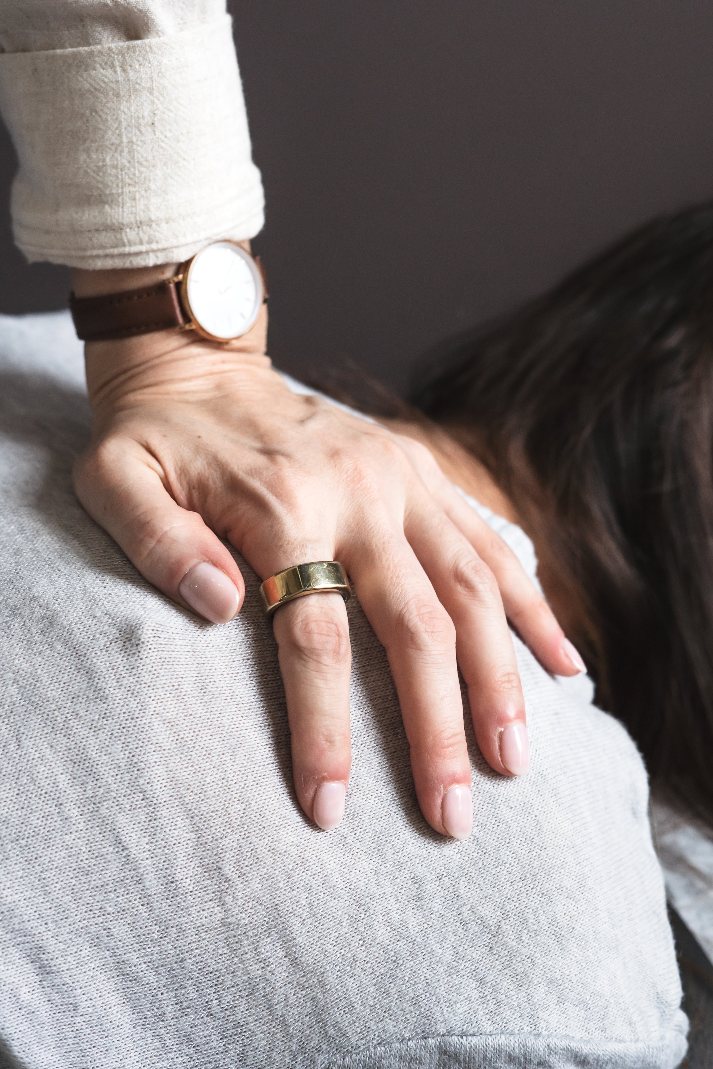 A closeup of the hand of a chiropractor from Brantford Ontario Canada while she adjusts her patient.