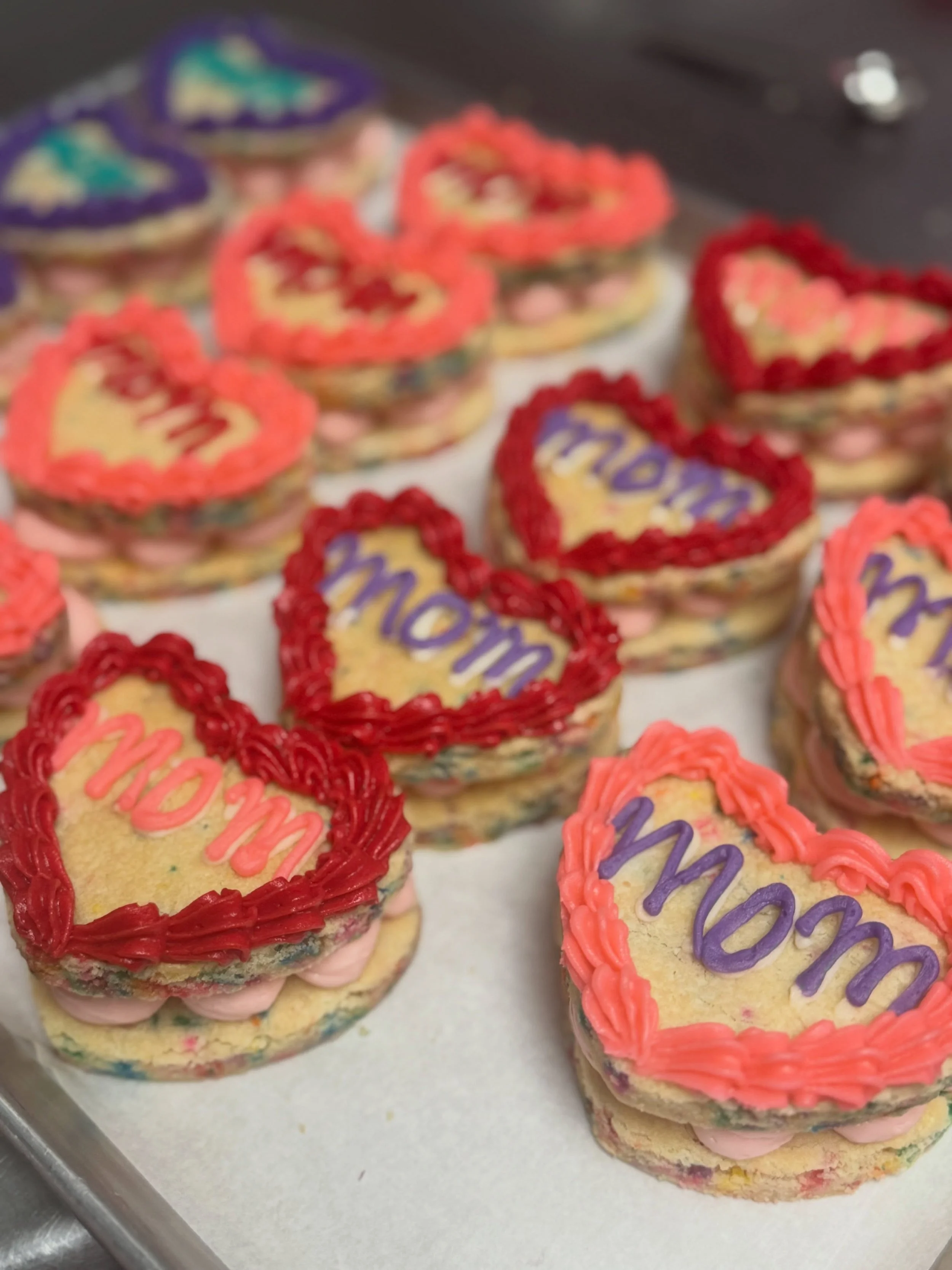 Celebrate Mom with something sweet🩷 birthday sugar cookies filled with raspberry cheesecake + buttercream decorations on top available at all locations!
