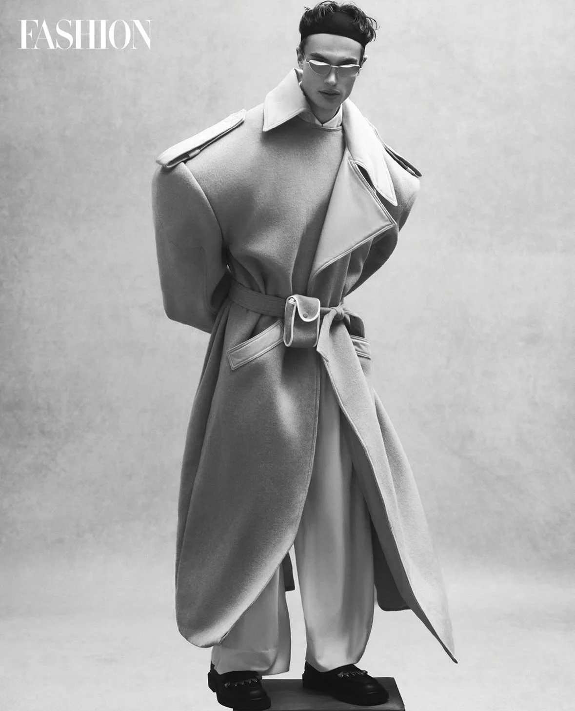 Here is a glamourous option without any dashes or hyphens:

&bull;&bull;&bull;
#repost

@fashioncanada Menswear steps into a new era this season. A monochromatic vision transforms into something bold sculptural and almost surreal. A study in shape mo