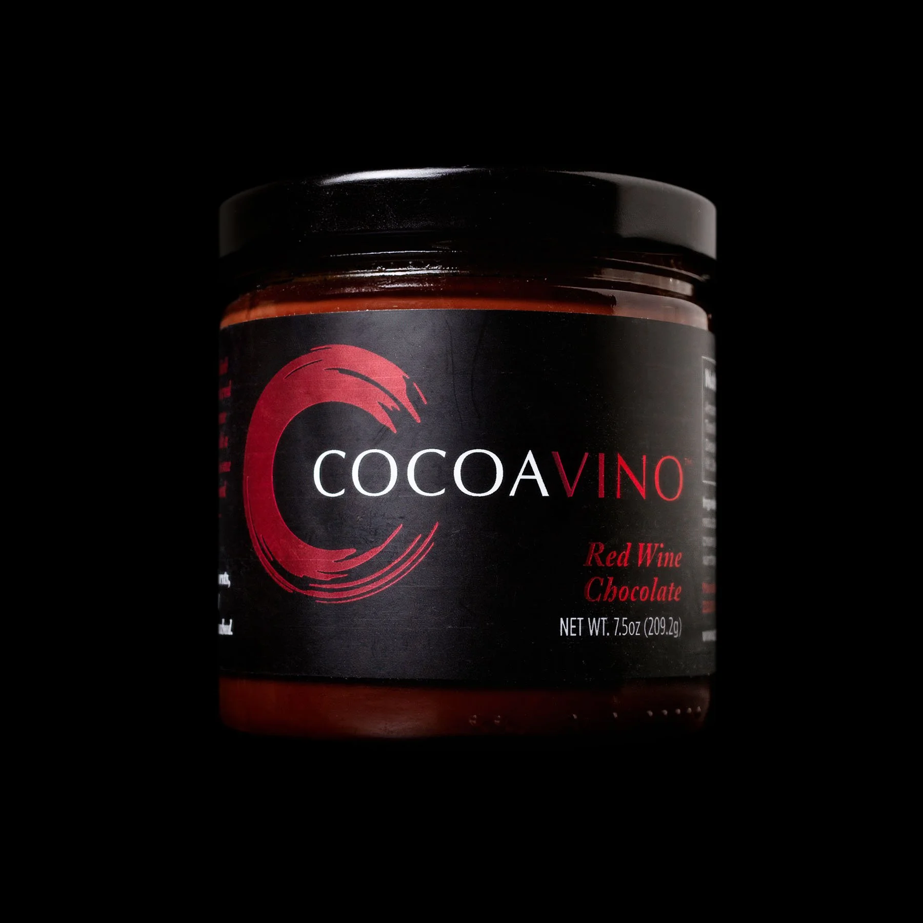 A jar of Cocoavino Red Wine Chocolate against a black background, featuring the brand’s signature red and black label.