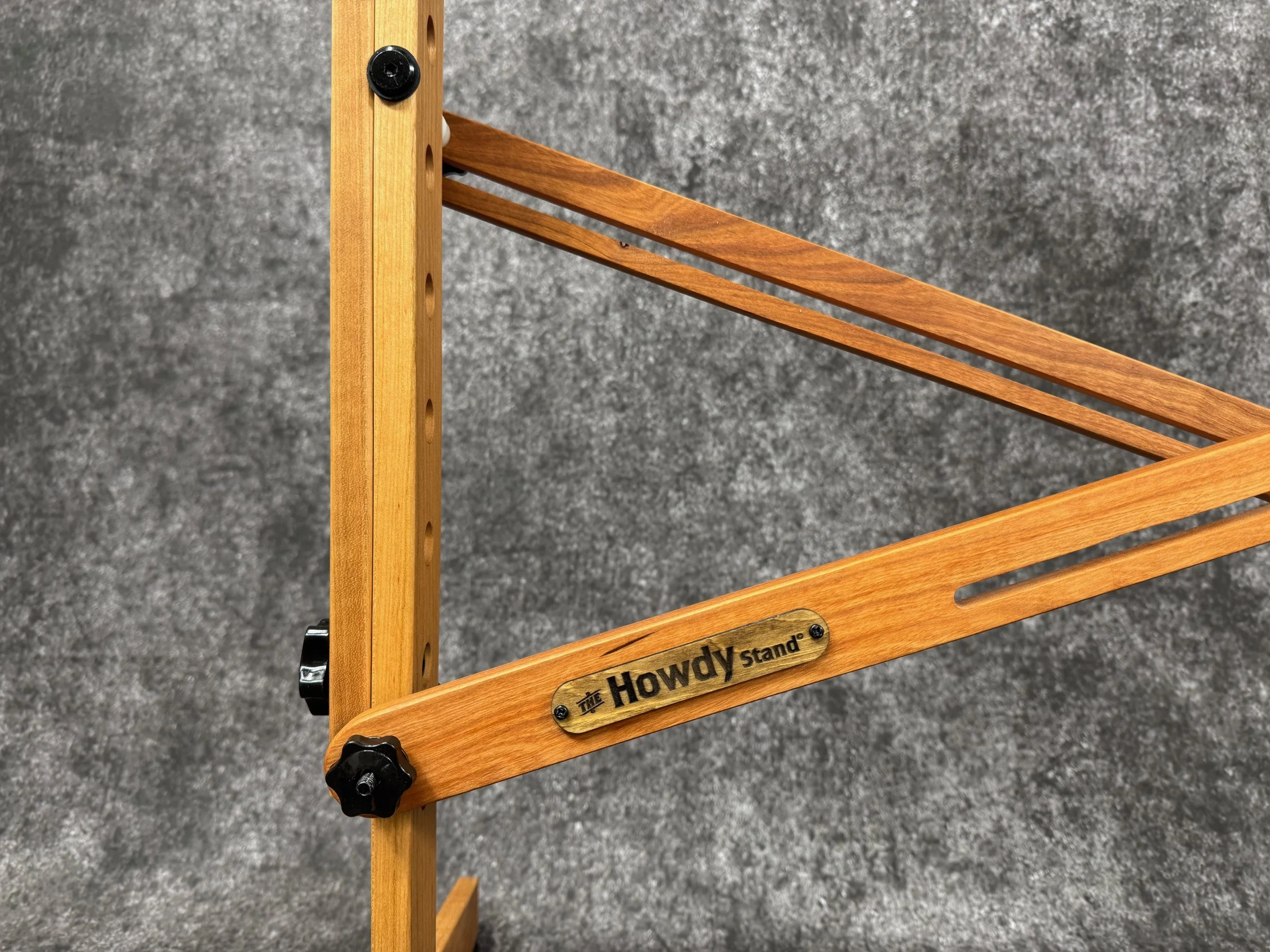 Close-up view of a mountain dulcimer stand x-brace, with a label that reads 'The Howdy stand'.