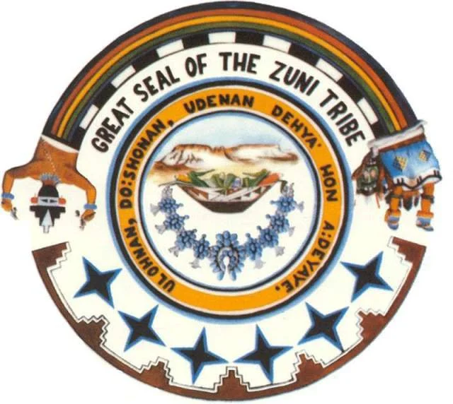 Seal of the Zulu tribe with a central emblem showing mountains, a spear, and traditional symbols, surrounded by the text 'Great Seal of the Zulu Tribe' and a band with the names of various Zulu clans.