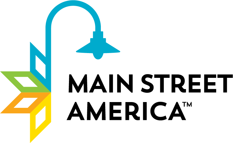 A stylized logo featuring a blue outdoor shower with water flowing from the showerhead, and colorful overlapping leaves in green, yellow, and orange on the left side.
