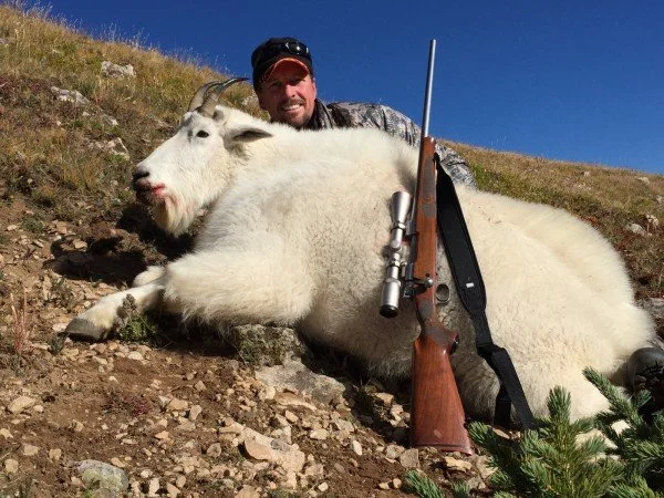 Hunter with mountain goat billy harvested on a guided hunt in the Maroon Bells-Snomass Wilderness in unit G12