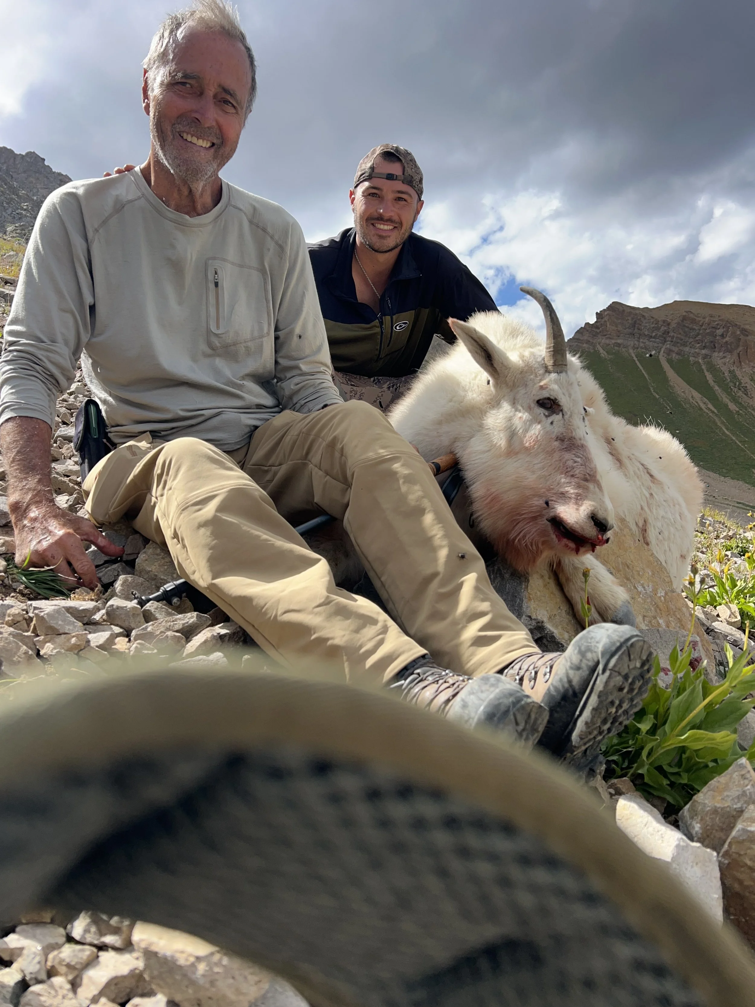 Hunter and guide with mature billy mountain goat in Colorado G12 wilderness