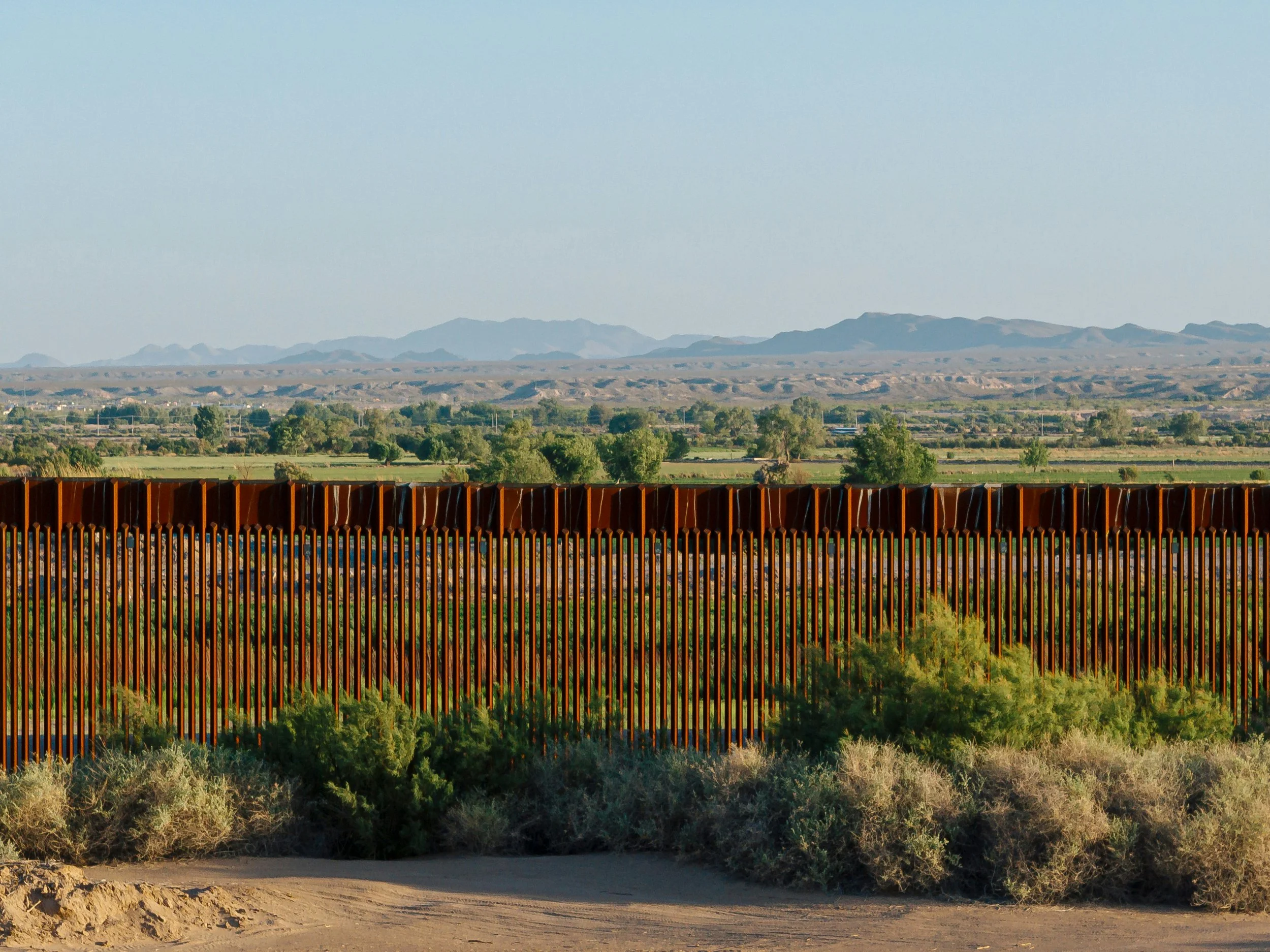 Image of a fence in front of mountains
