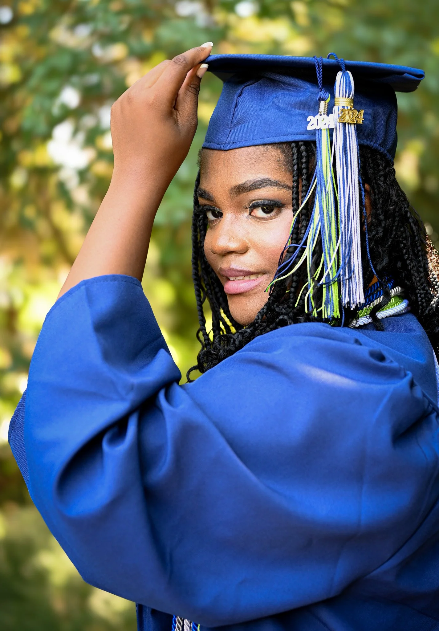 Graduate in blue cap and gown portrait in Rocky Mount, NC by Noel Butler Photography