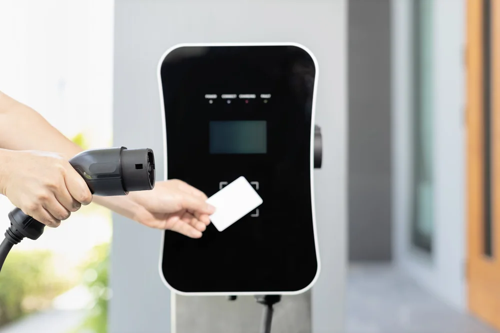 Driver using a card at an EV charging access terminal