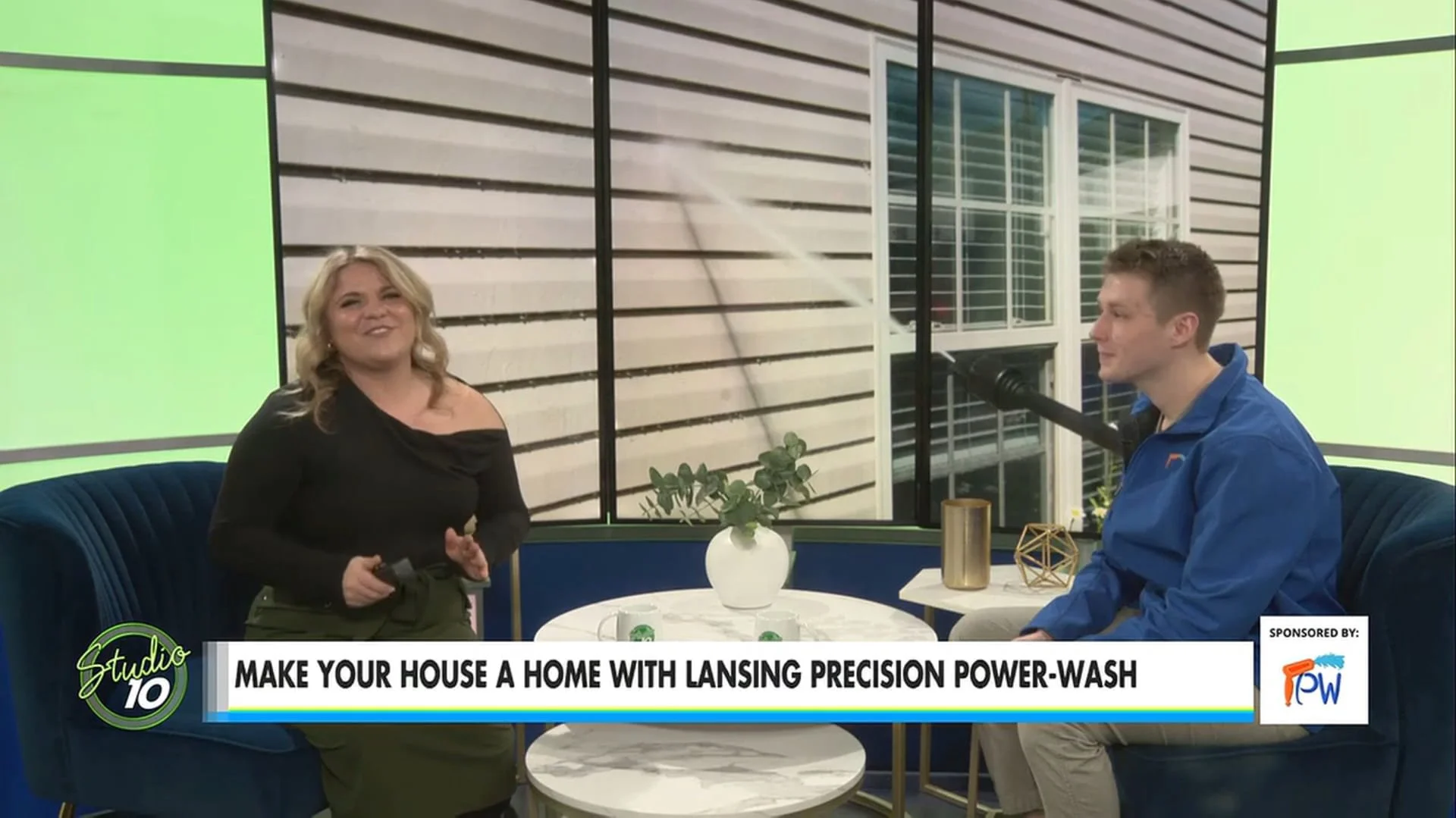 Adam from Lansing Precision Power-Wash sitting across from WILX host in the WILX studio 10 room; both smiling