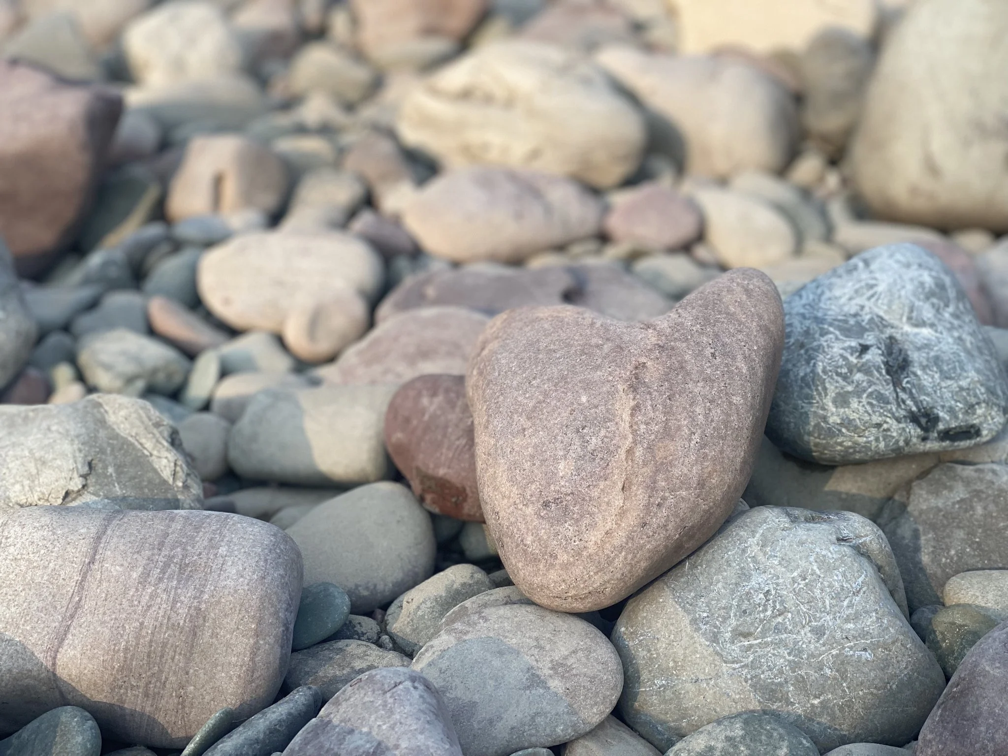 A naturally formed heart-shaped stone, symbolizing protecting and caring for the heart with intention and compassion.