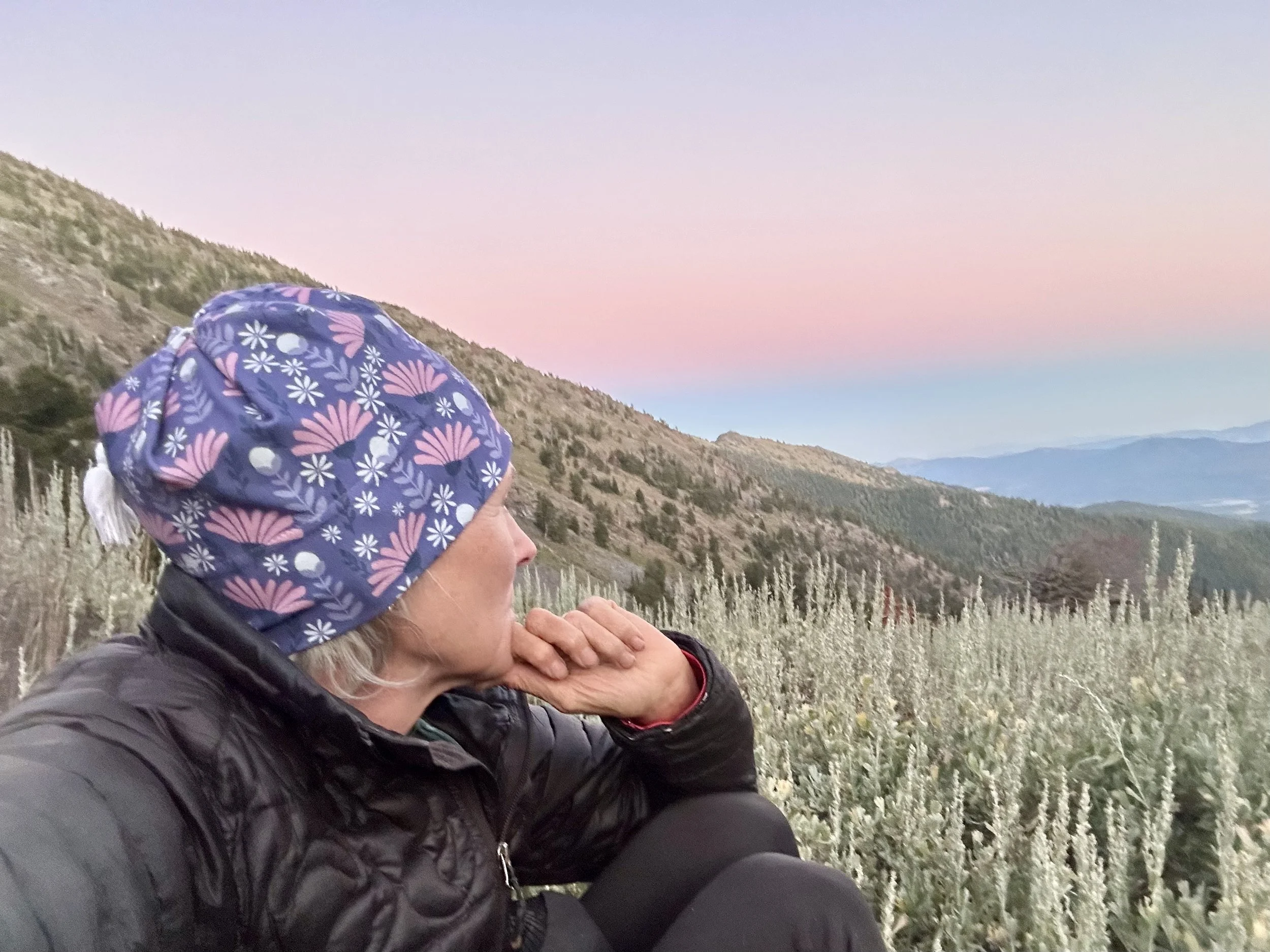 Midlife woman pausing outdoors at dusk, reflecting on purpose, balance, and vitality during life transitions.