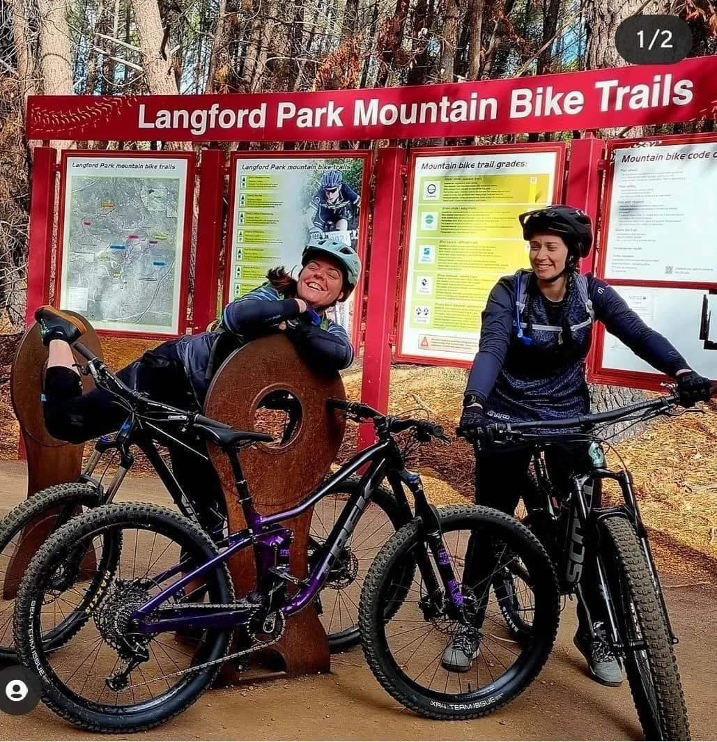 Adventure Physio, Stephanie Lock and her friend pose with mountain bikes at Langford Park, showcasing the adventure and beauty of the trails in Jarrahdale.