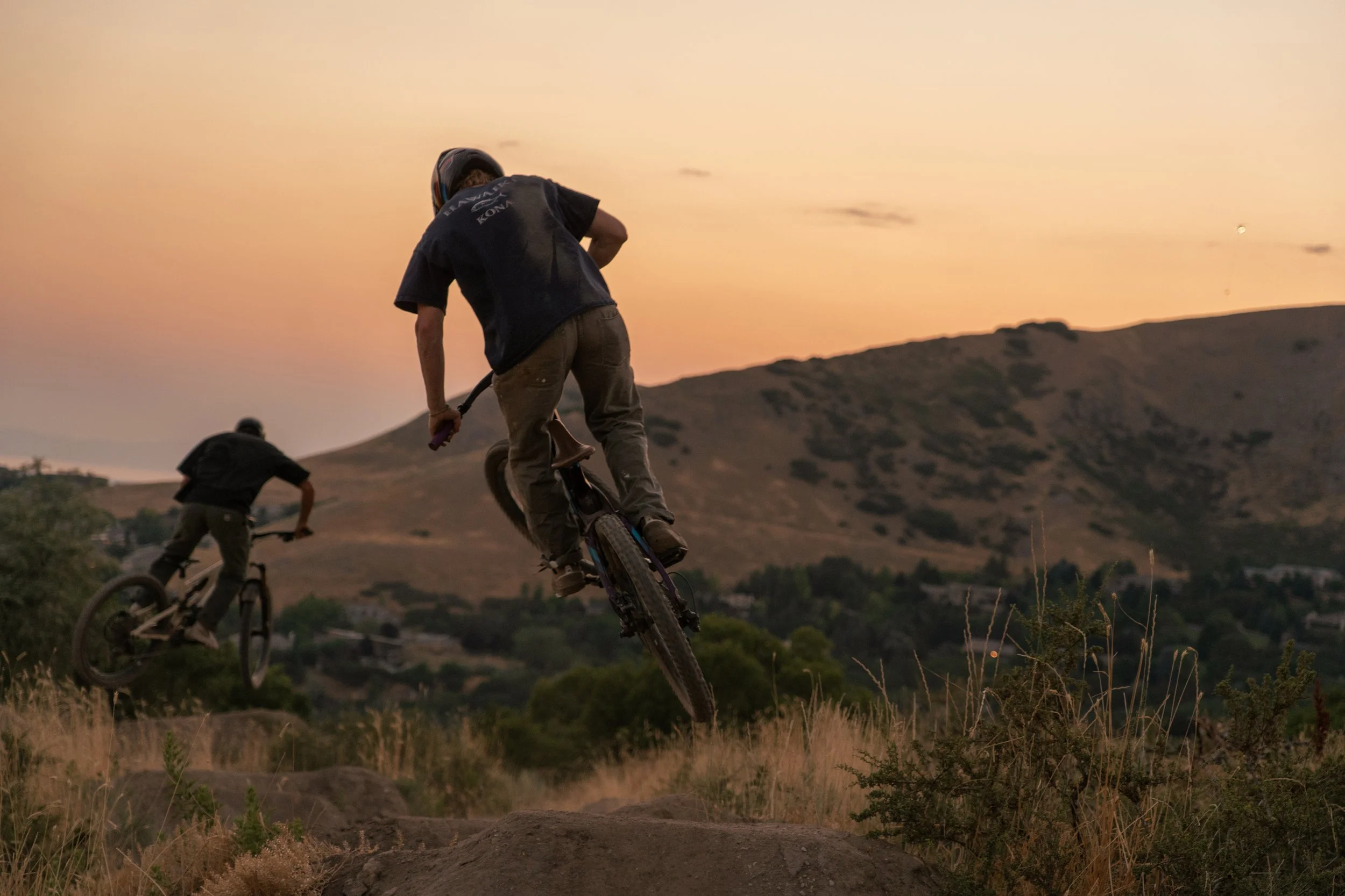 Two Mountain Bikers Hitting Jumps At The Same Time | Photography by Anders Henrikson Photo 