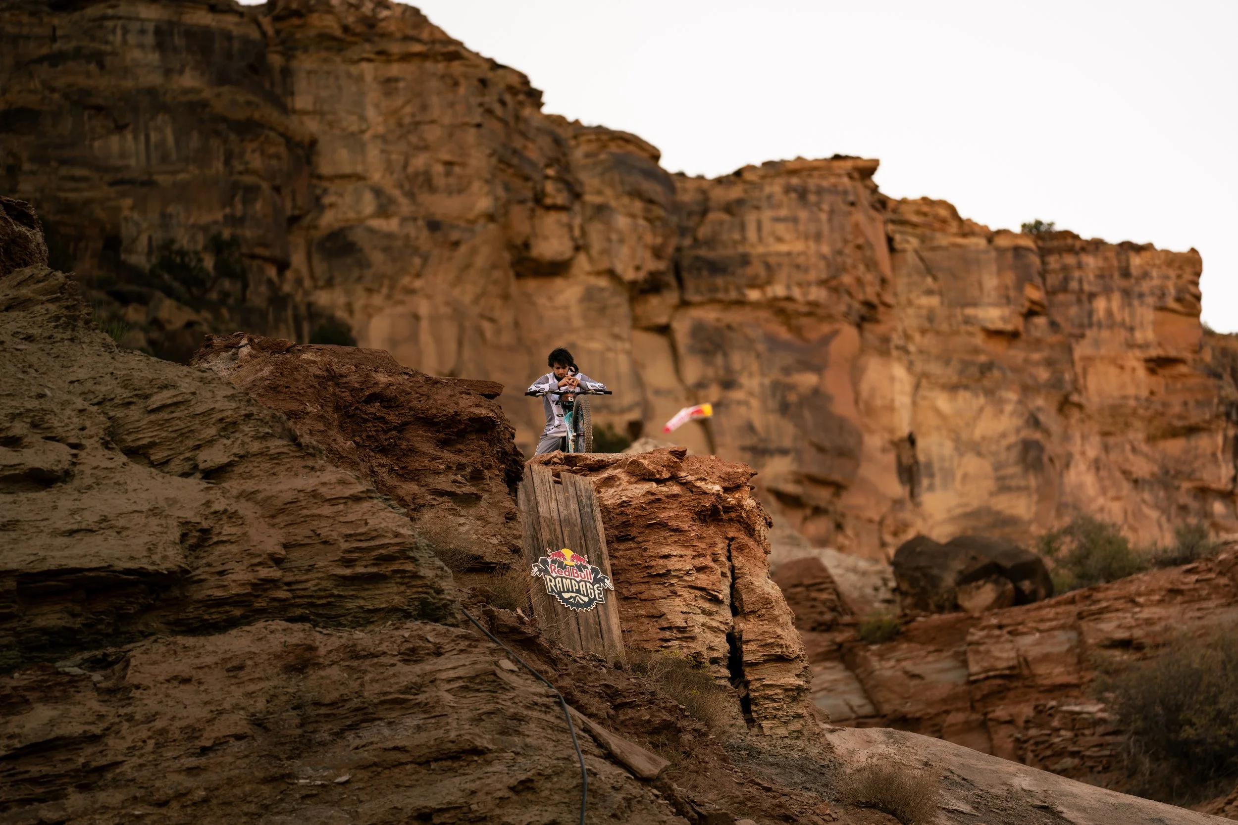 Mountain biker prepares to descend rocky trail at Red Bull Rampage.