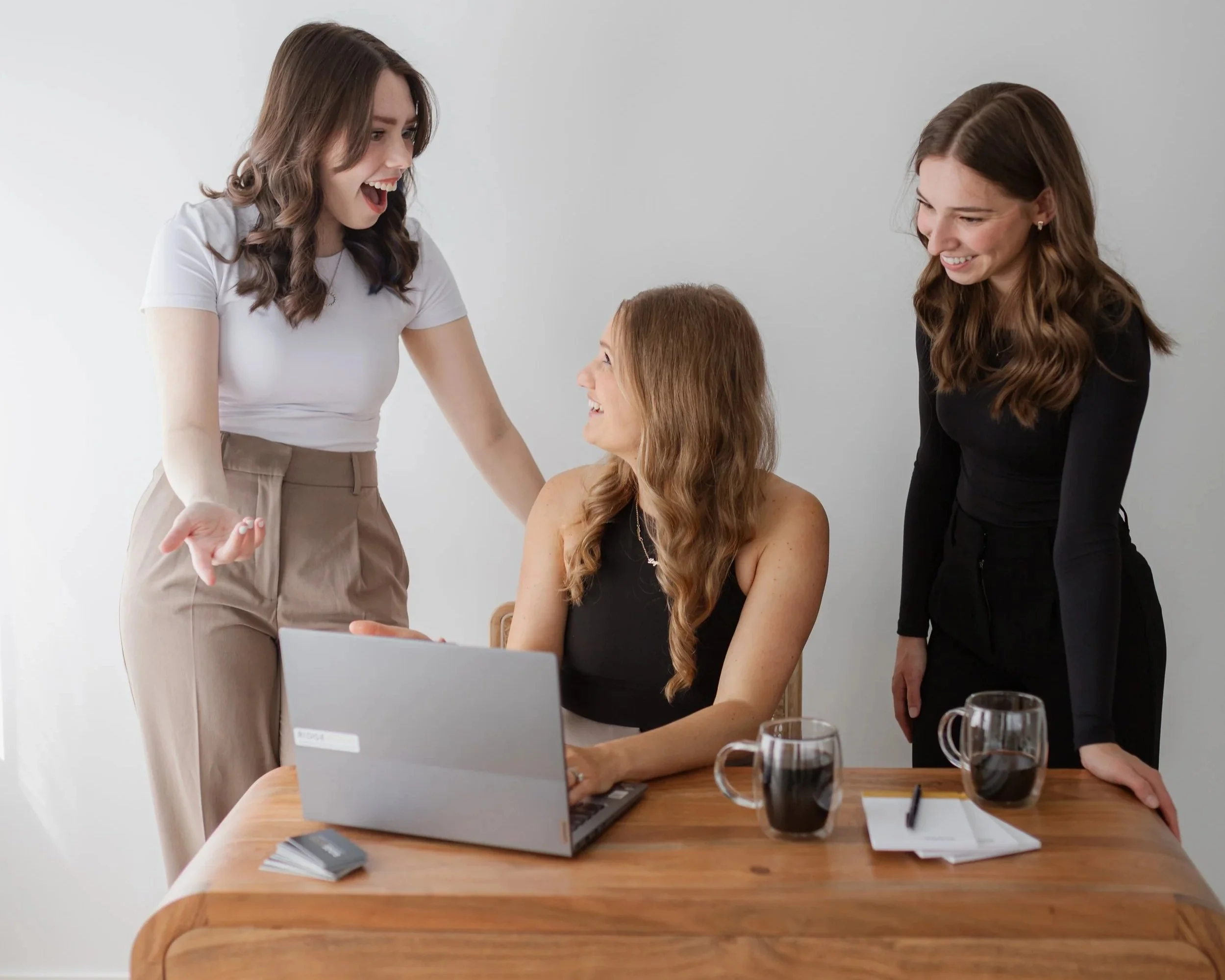 RidgeWood CPA team members discussing a client file over coffee in the office