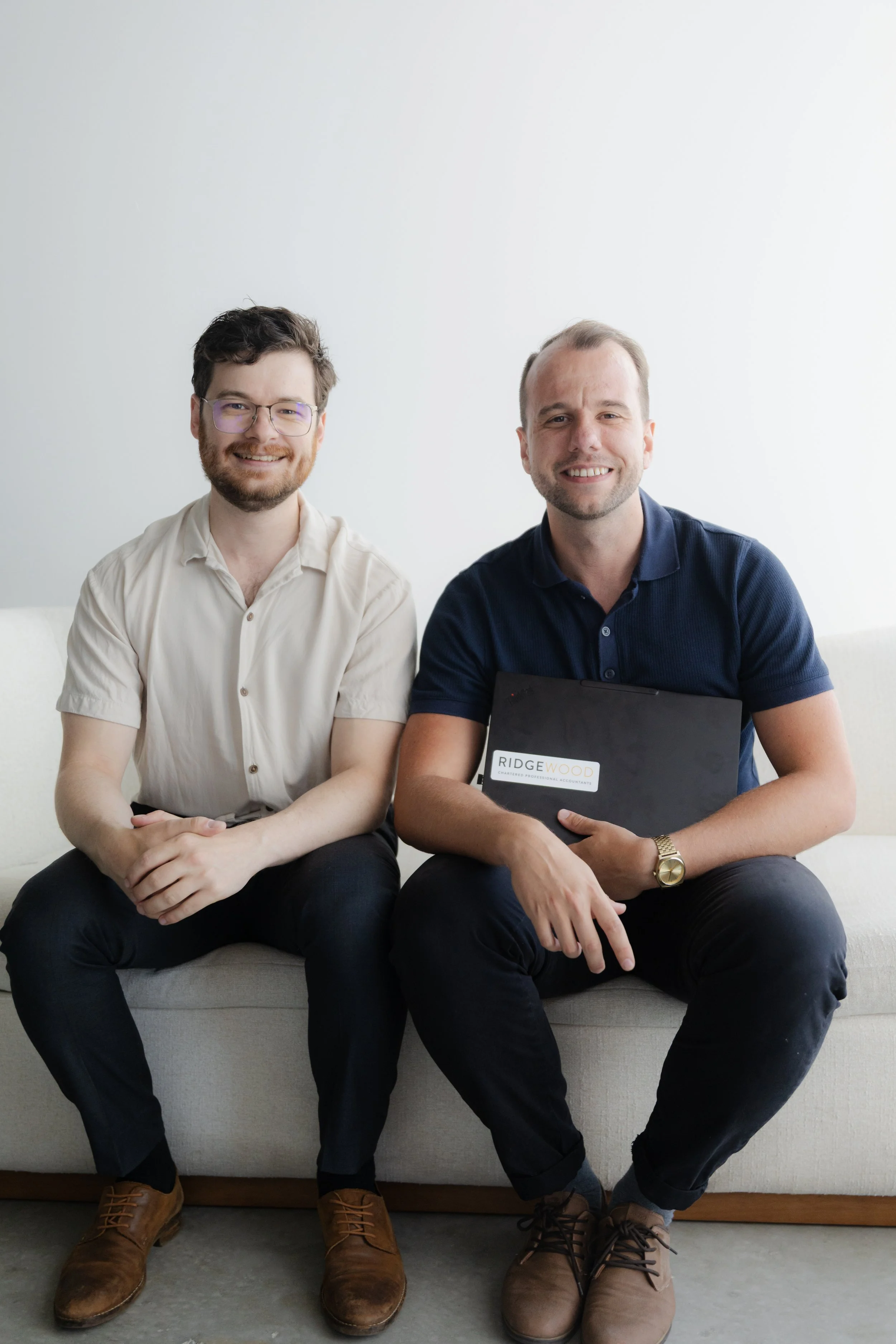 Two RidgeWood CPA team members smiling together in the office