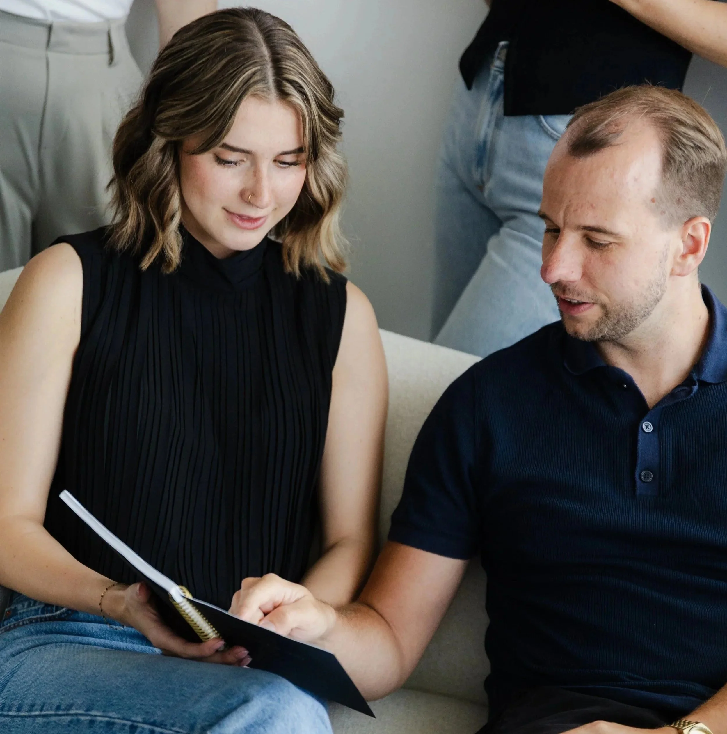 RidgeWood CPA team members reviewing a client’s financial report on a phone