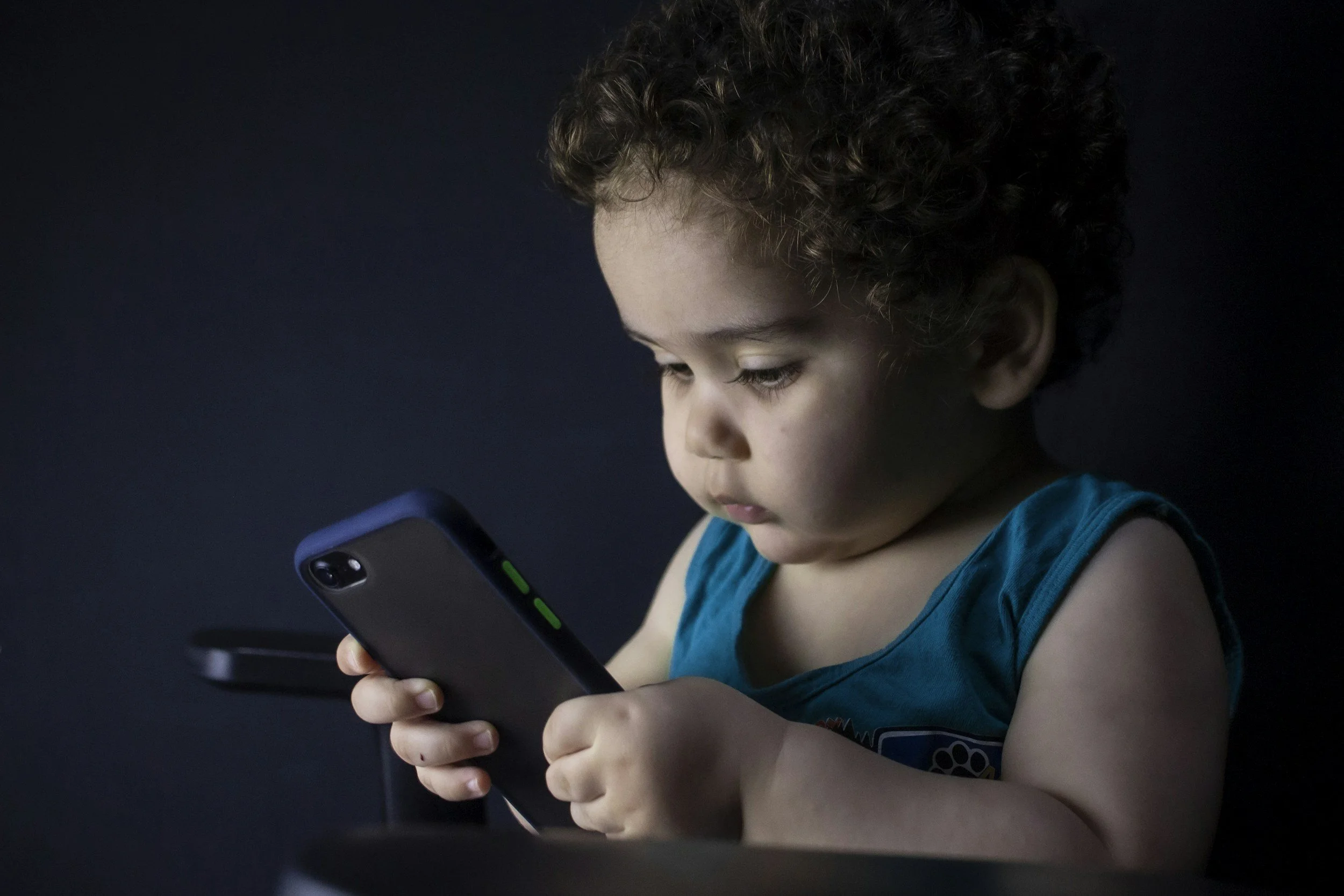 Toddler boy holding mobile phone