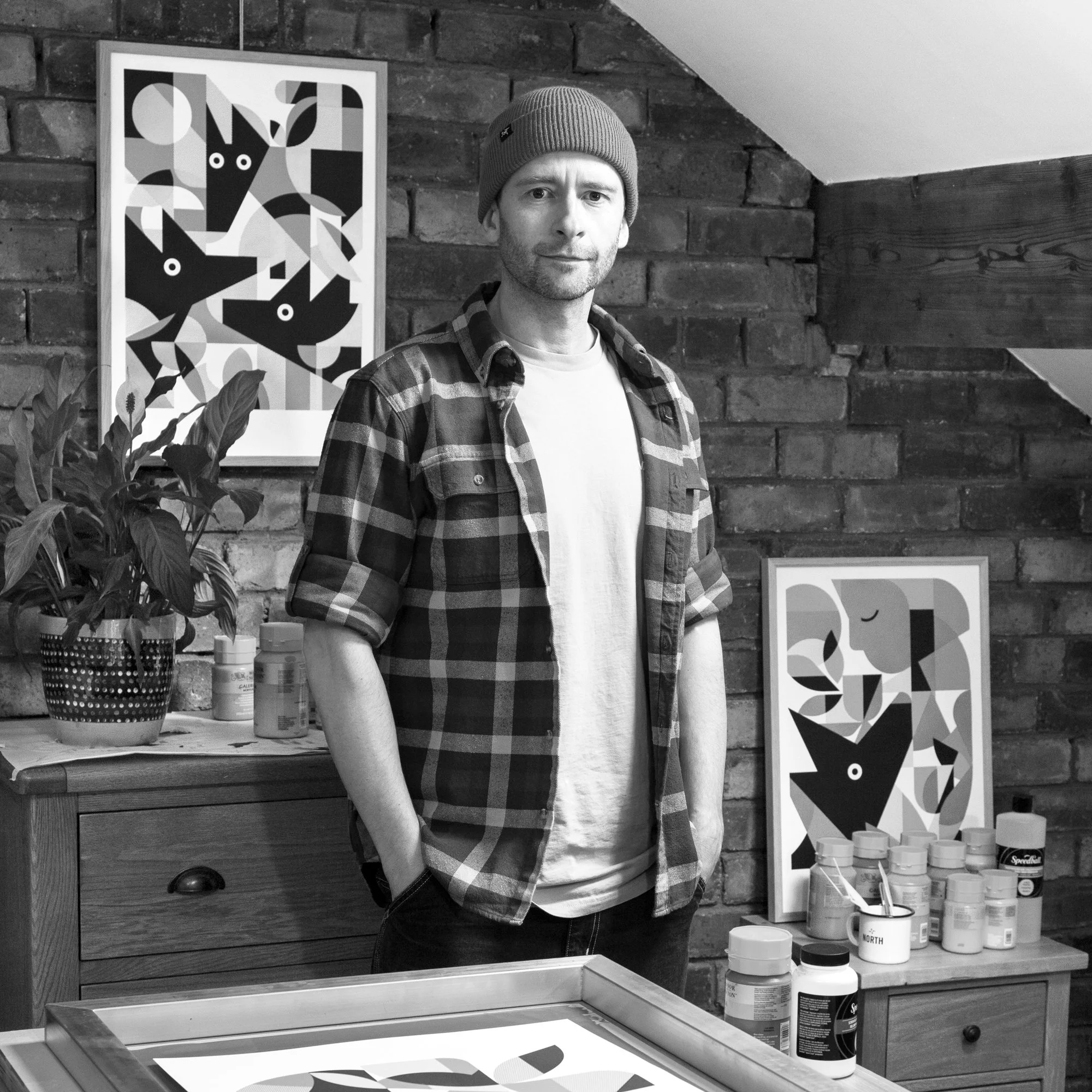 Artist Jim Fox, with some of his artworks, in his screen printing studio in Yorkshire.