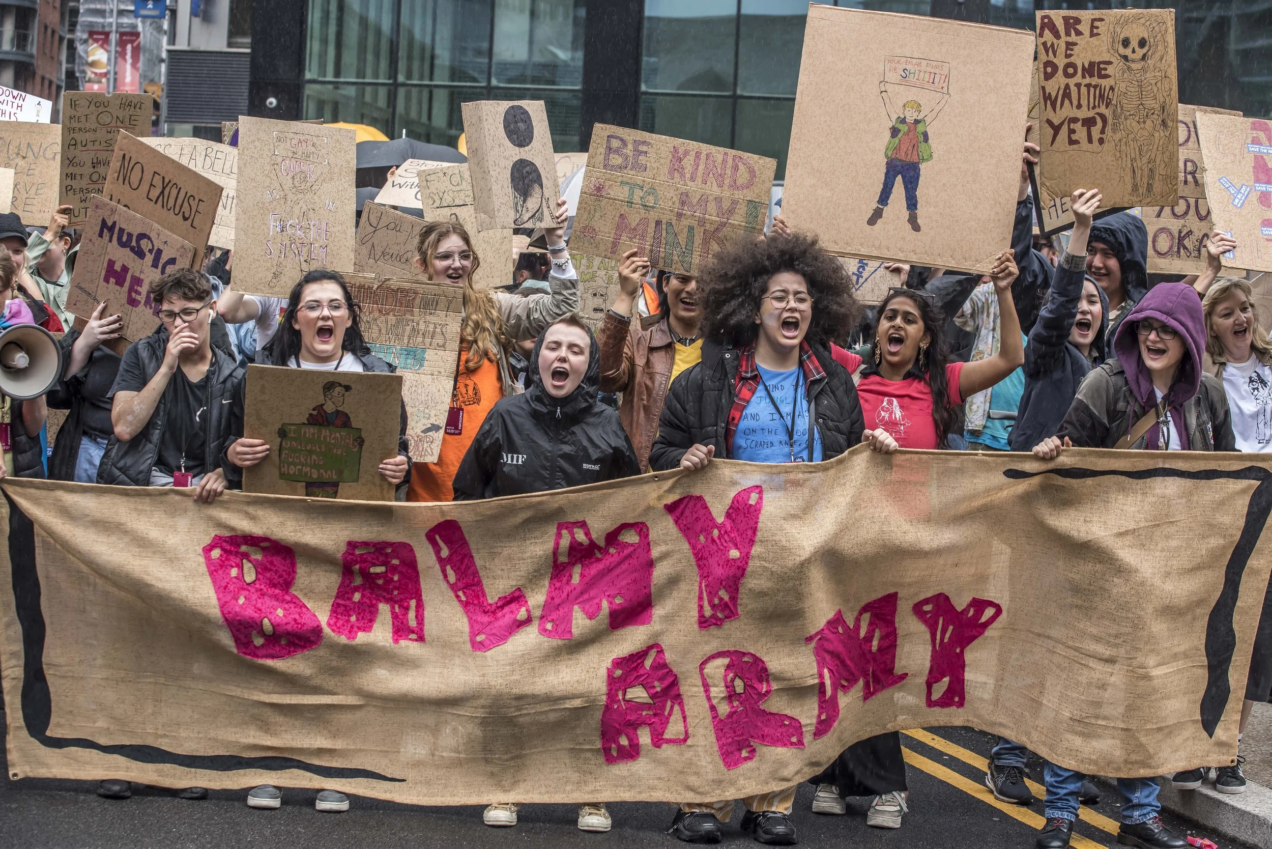 People holding cardboard banners and marching