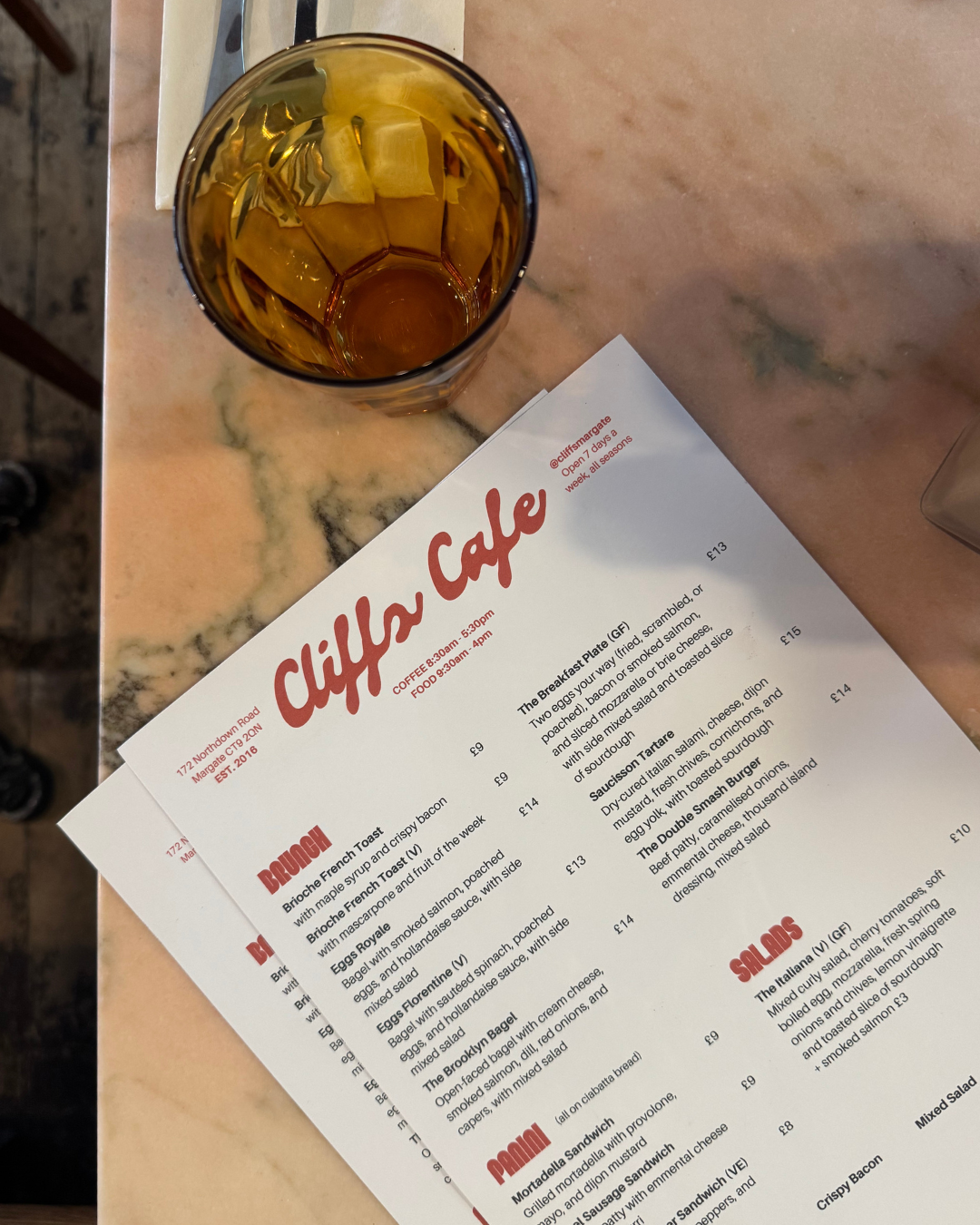close up of a menu on a pink marble table