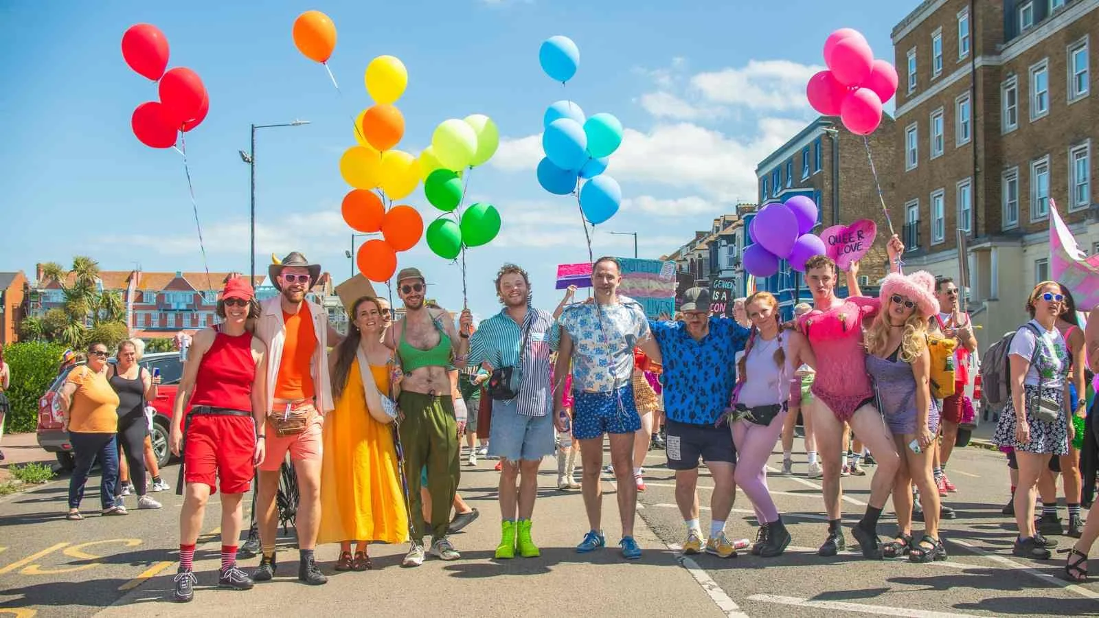 colourful people with rainbow balloons stood in Margate
