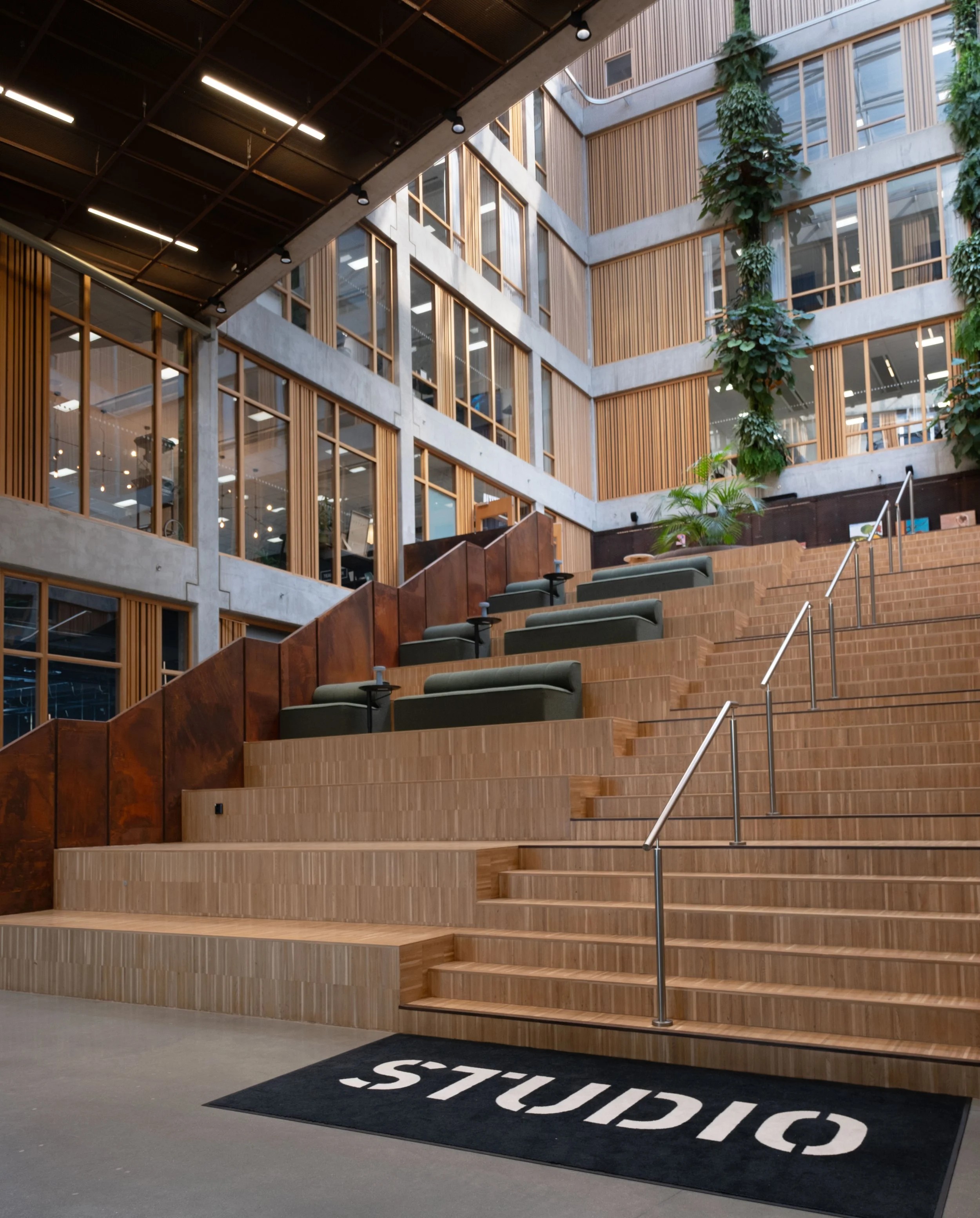Shared meeting space with tiered seating and coworking areas