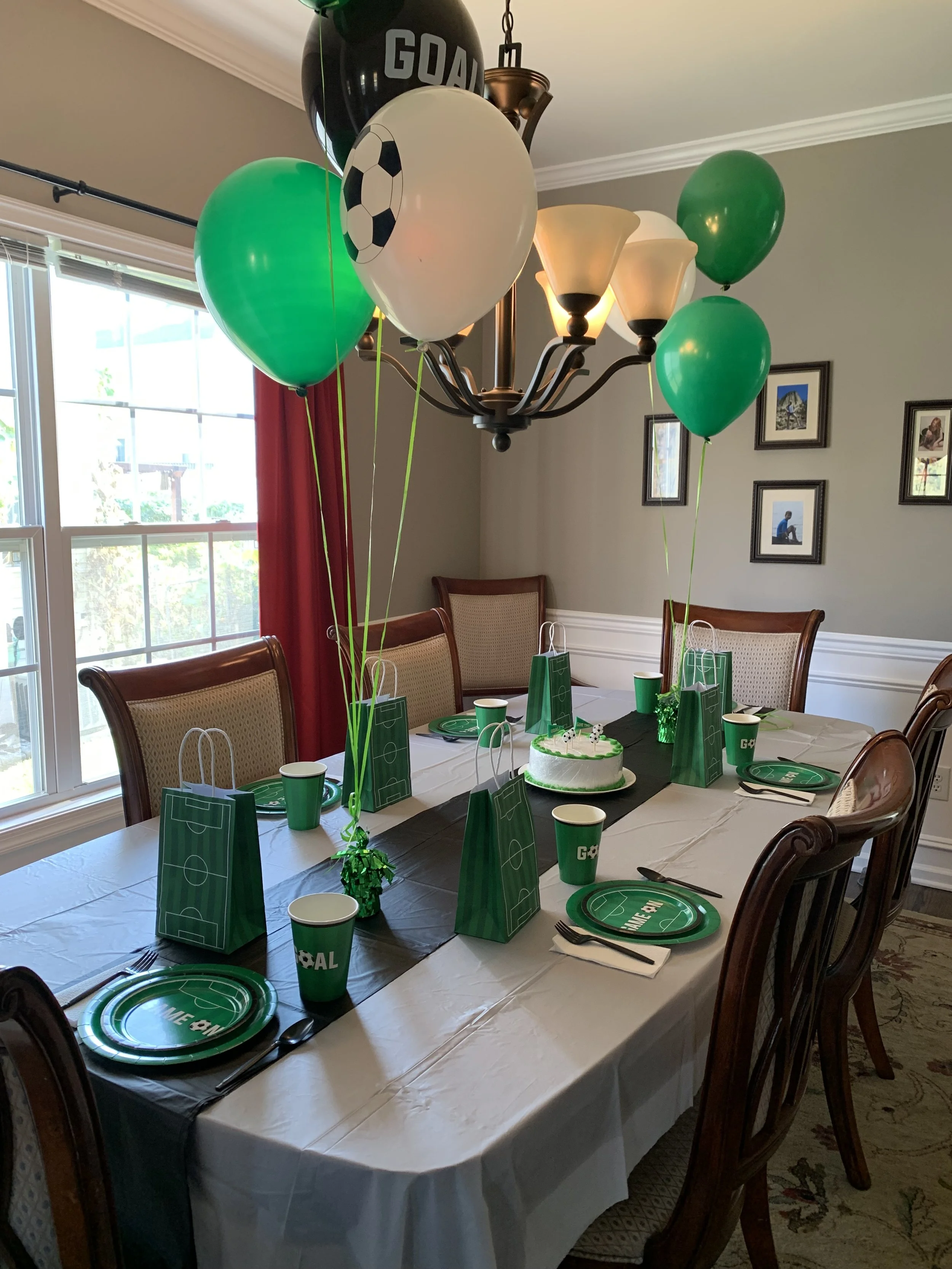 Invitation invitation for Christopher's 12th birthday party with a soccer theme. Green grass background, soccer ball in a goal net, black border with a green glittery outer border. Details: Saturday, 10 May at 2 pm, Hedden Park Field.