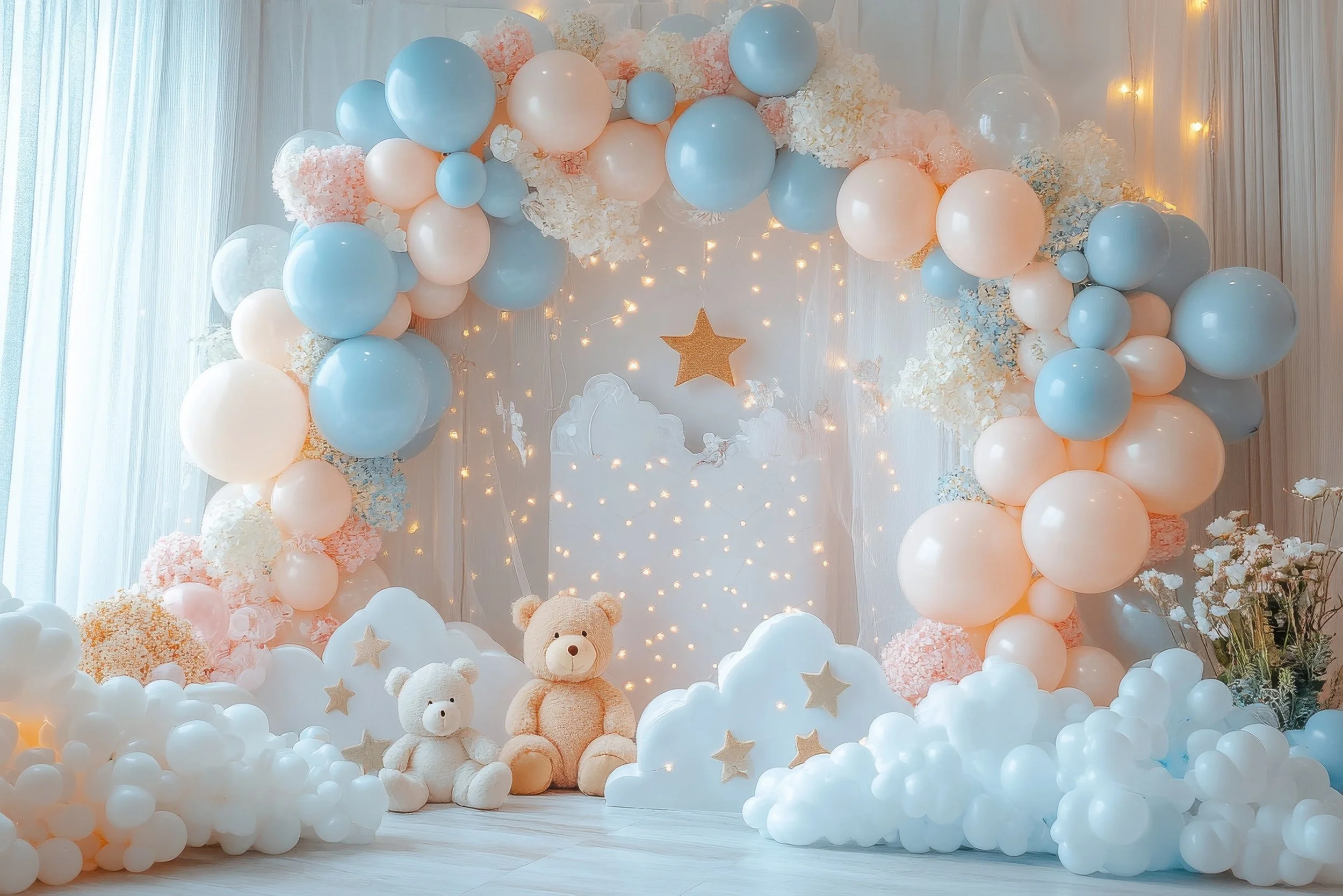 Decorative backdrop with pastel blue, pink, and white balloons, plush teddy bears, cloud-shaped decorations, and string lights with a gold star as part of a celebration or event setting.