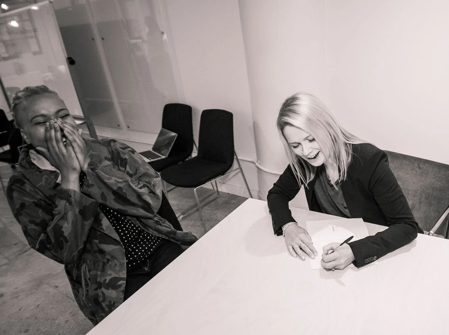 Michelle Lowbridge signing books at the New York book launch for Wealthology, 2017.