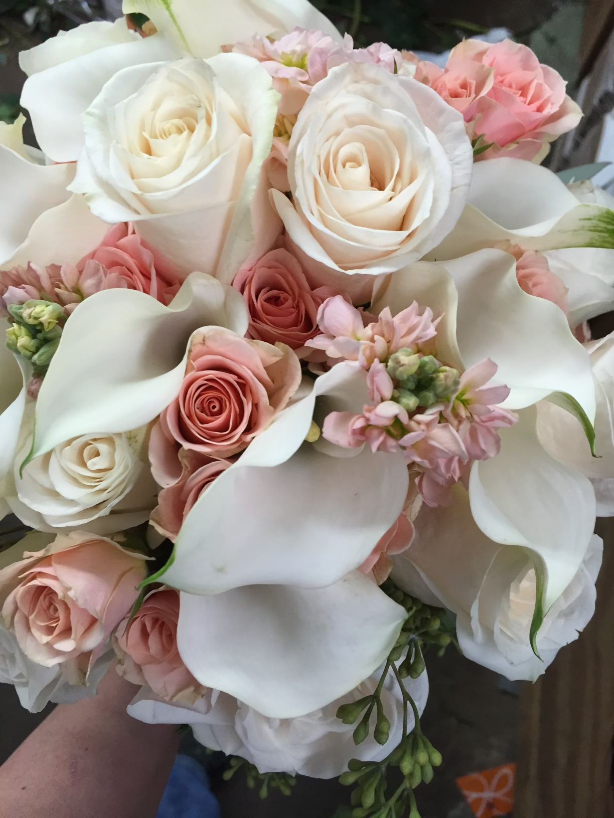 Bouquet of white roses, pink roses, and white calla lilies.