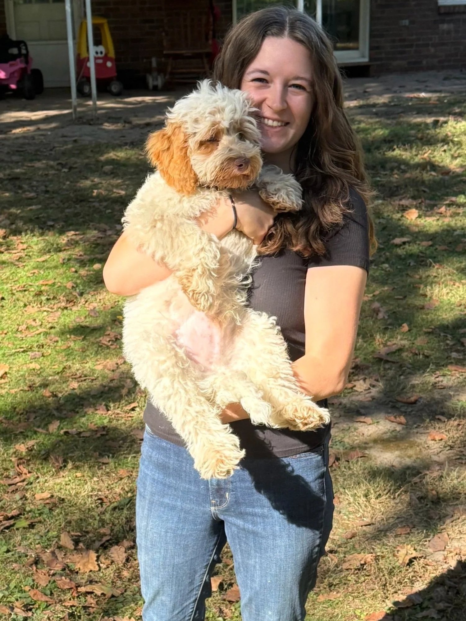 Elizabeth Walls holding an Australian Labradoodle in Anderson, Indiana