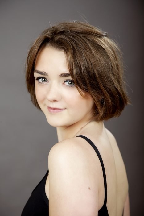 Celebrity Maisie Williams looks to the side in a headshot style photo.