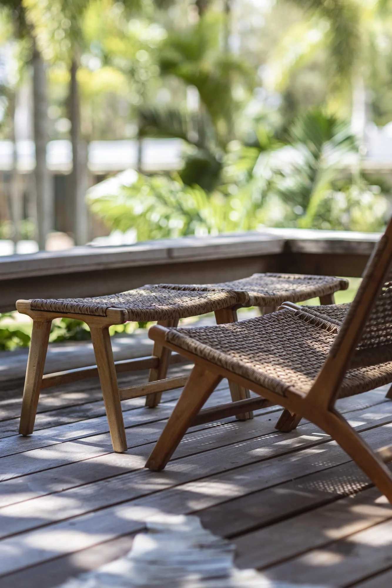 Handcrafted timber lounge chair on a sunlit private deck