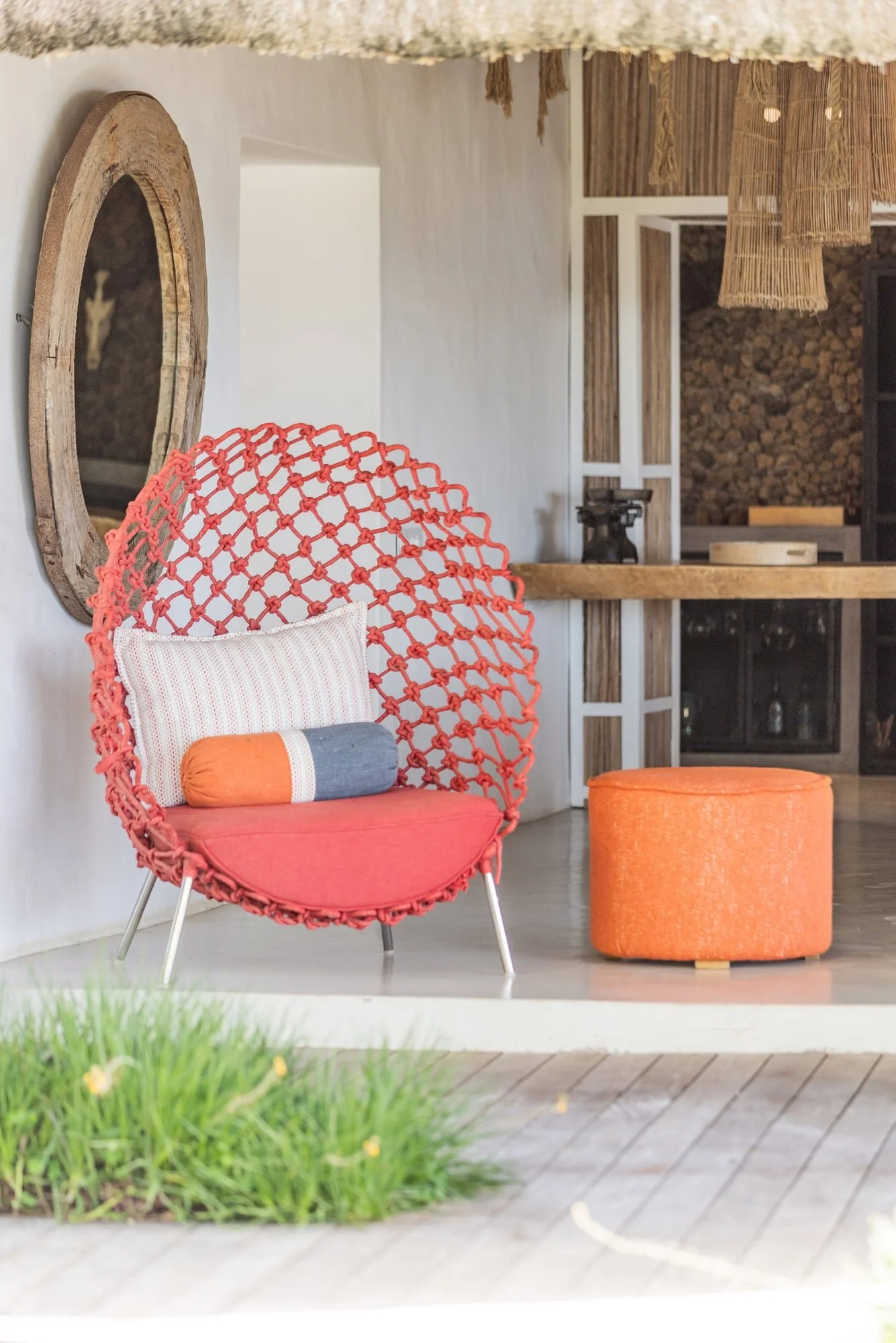 Colourful hanging chair and handcrafted furniture on a private terrace