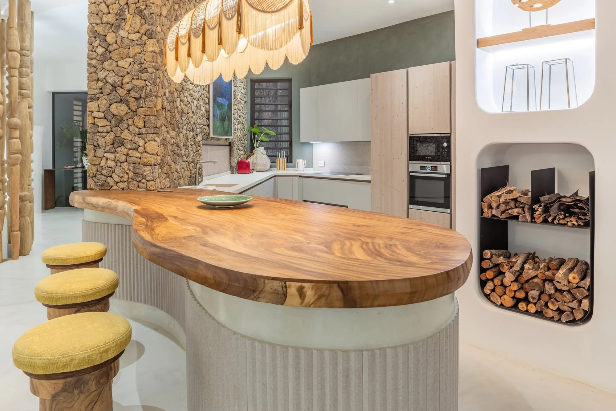 Sculptural live-edge timber island in a contemporary villa kitchen