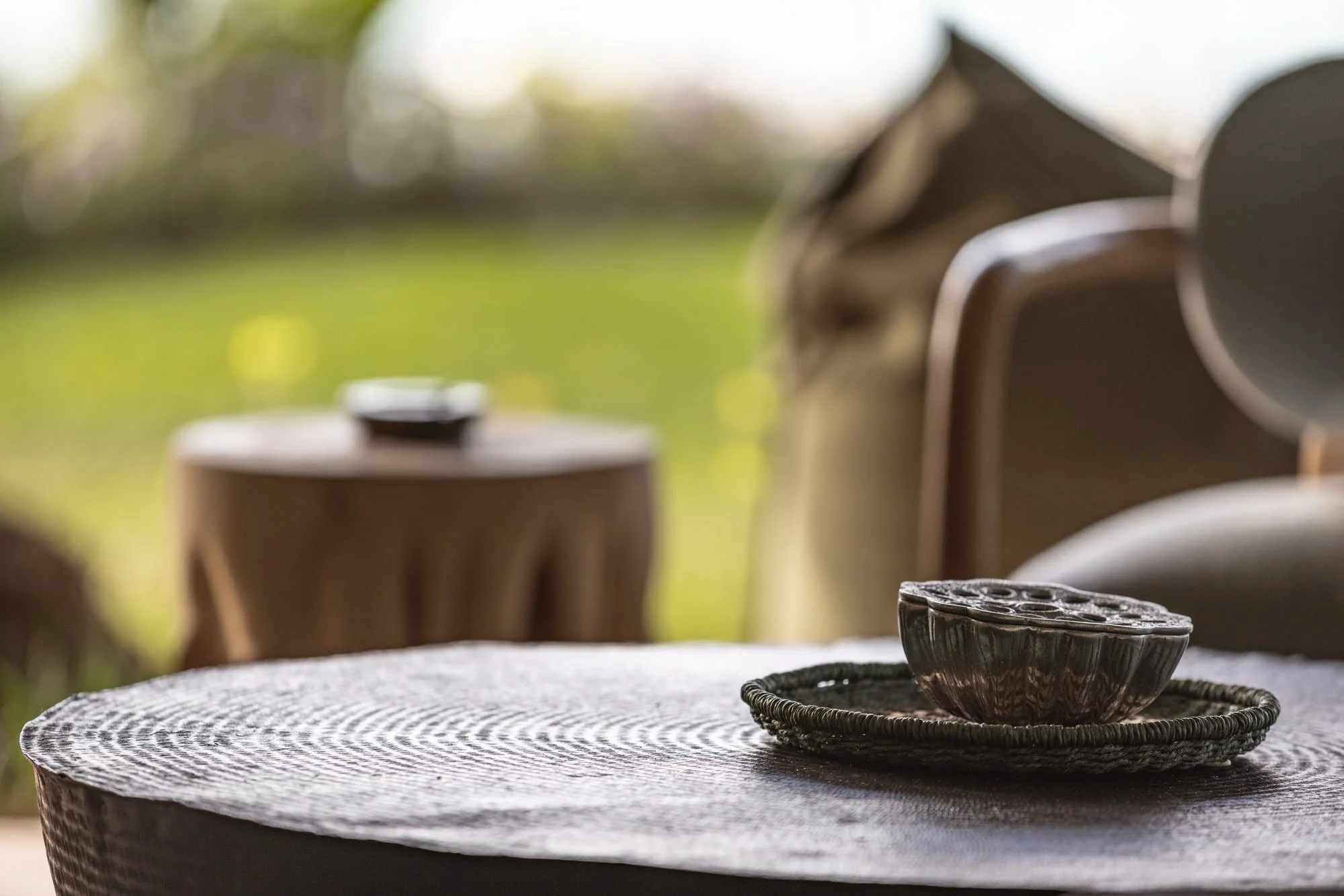Layered coffee-table styling with handcrafted ceramics and woven textures