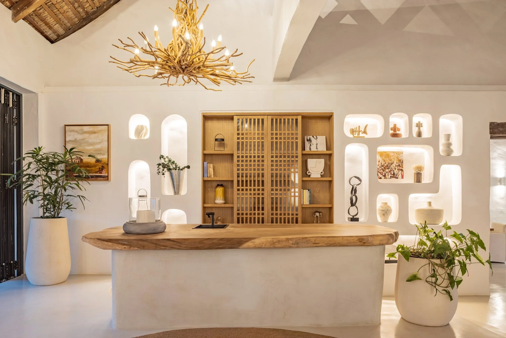 Sculptural entrance console framed by illuminated wall niches