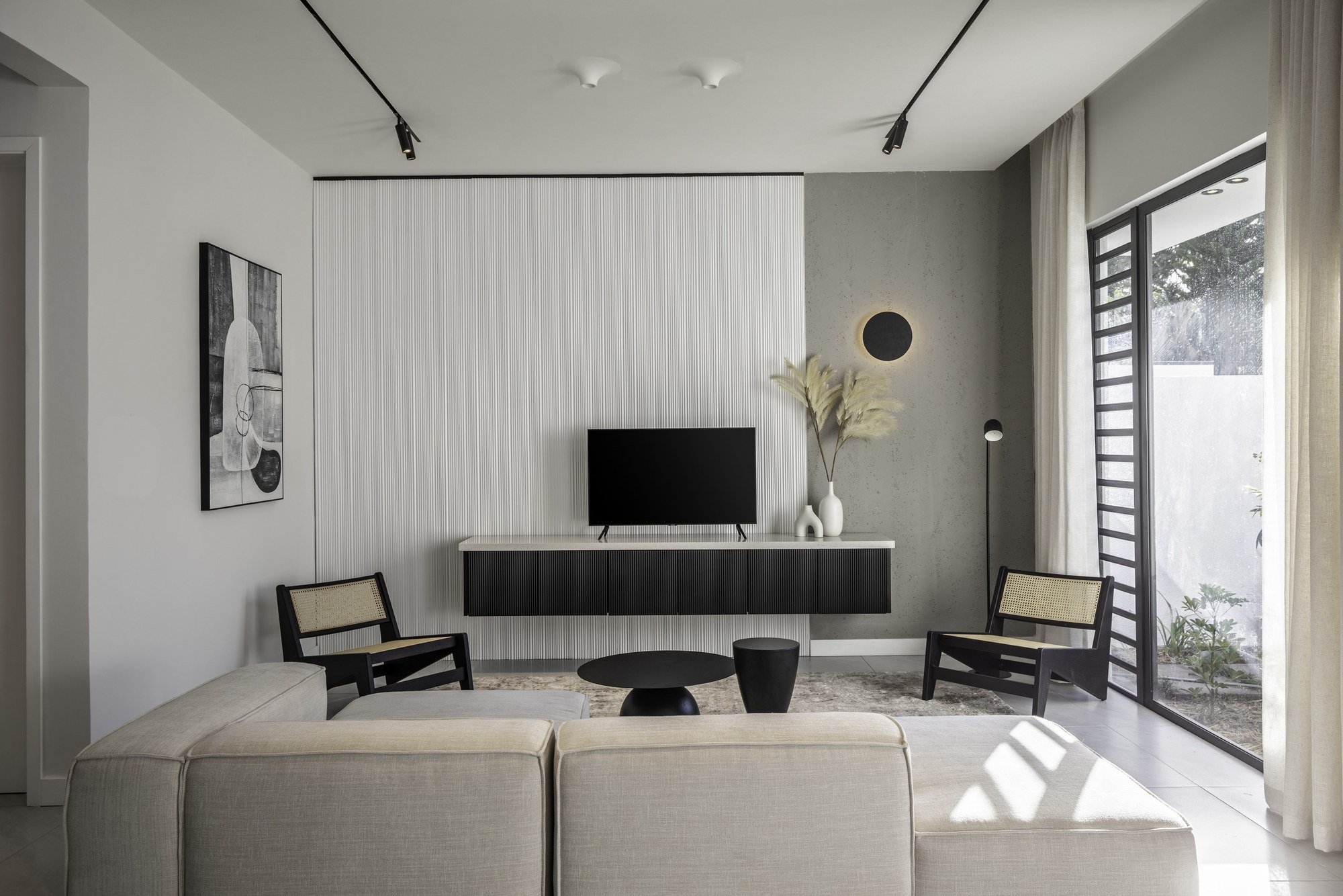 Intérieur minimaliste de la villa Nino, lignes épurées, tons clairs et ouverture sur le jardin.