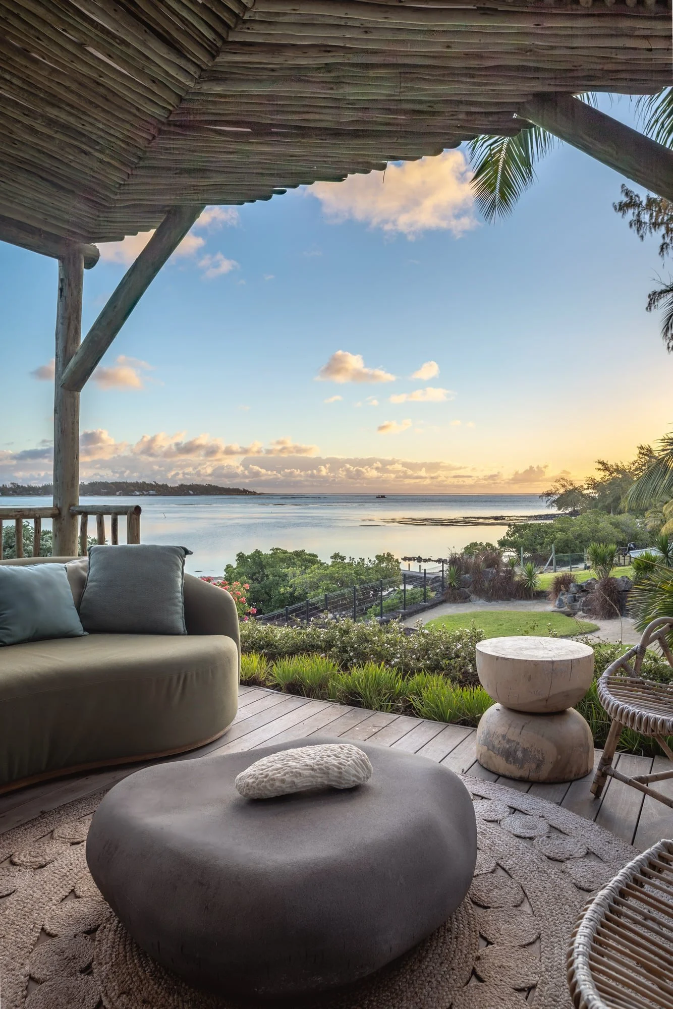 Intimate terrace lounge with a peaceful lagoon view at sunset