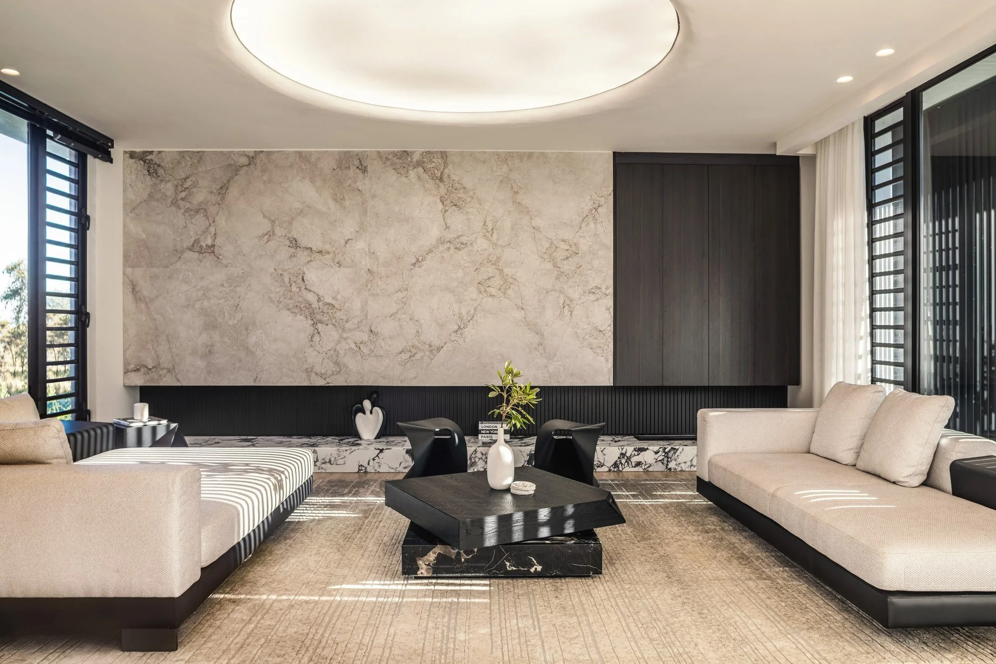 Formal living room with marble wall and circular ceiling light