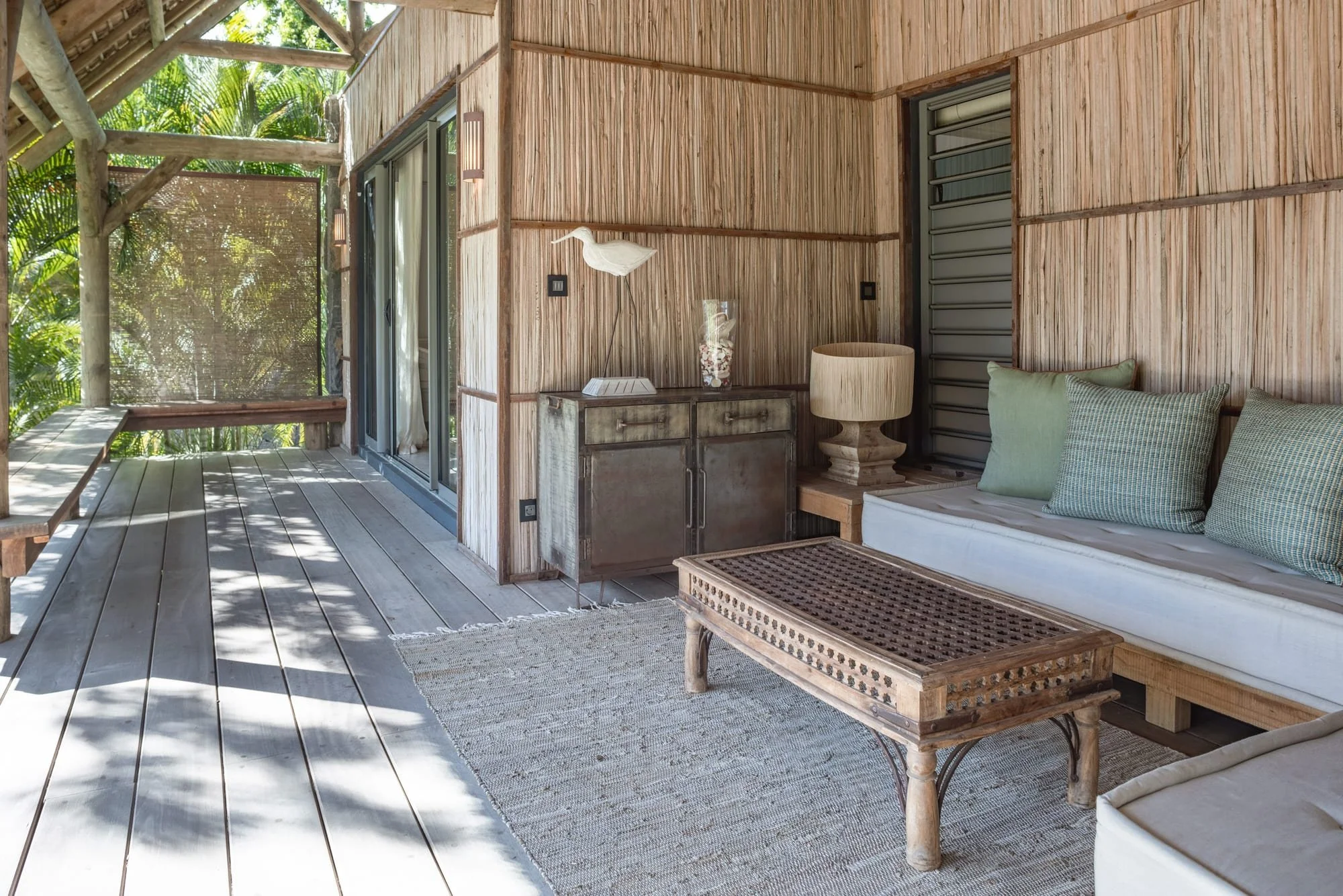 Shaded timber veranda lounge with handcrafted tropical furnishings